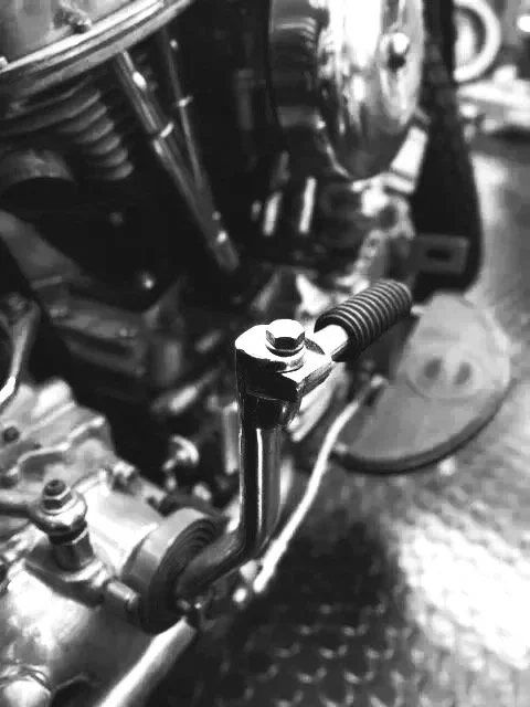 START - Contact - Close-up of mechanical engine parts, including a metal rod and bolts.