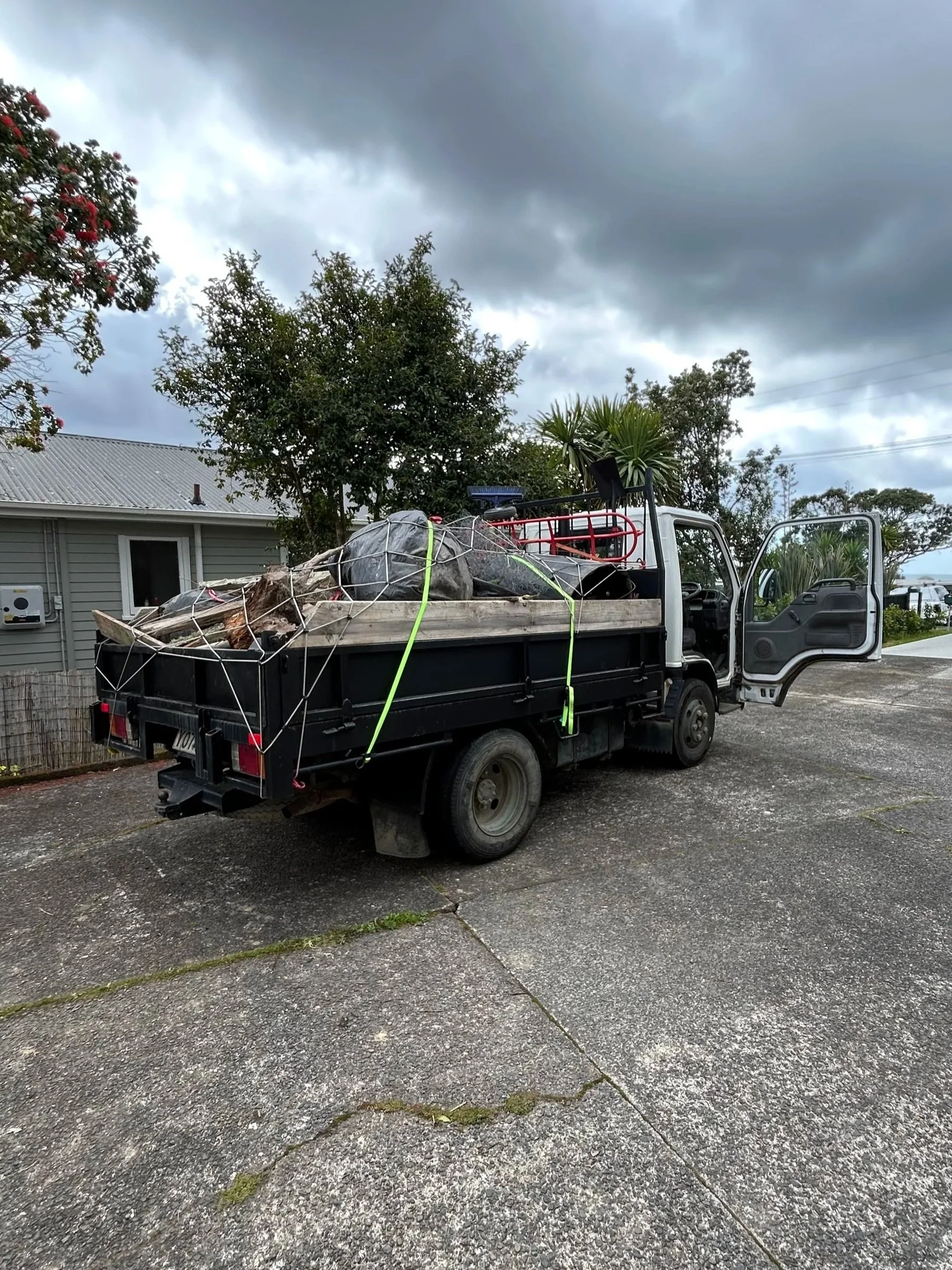 A pickup truck parked loaded with junk in the hibiscus coast.