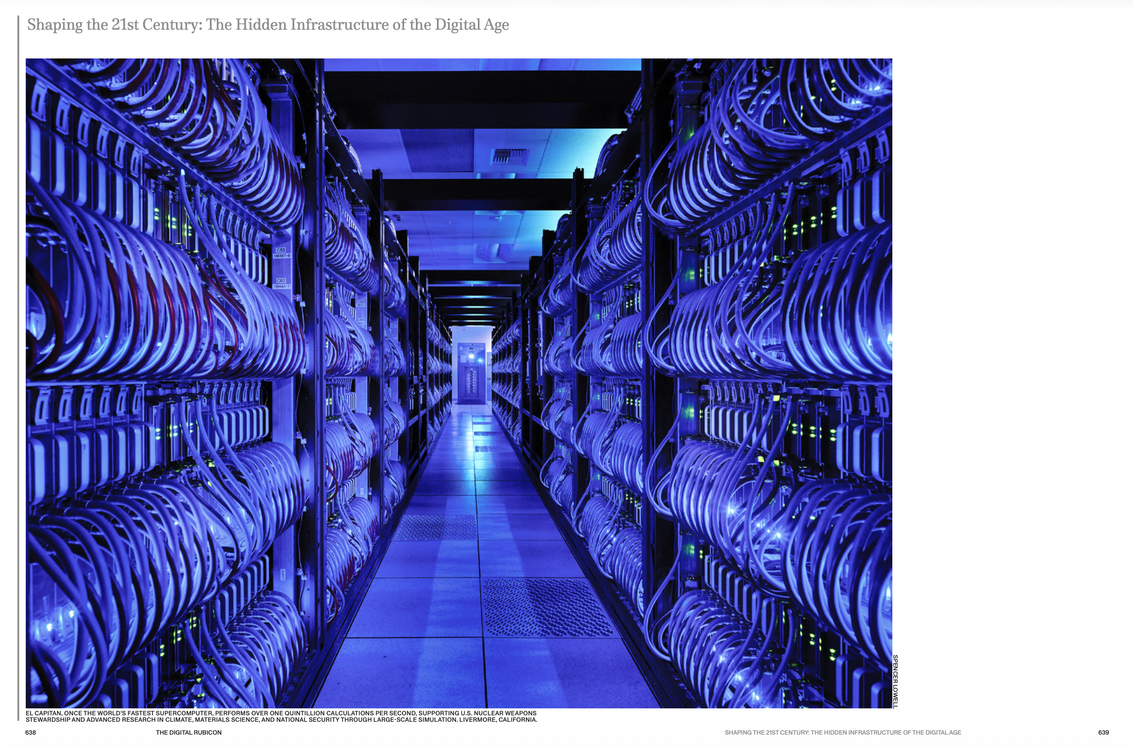 A data center with rows of server racks illuminated by blue lights, connected by numerous cables.