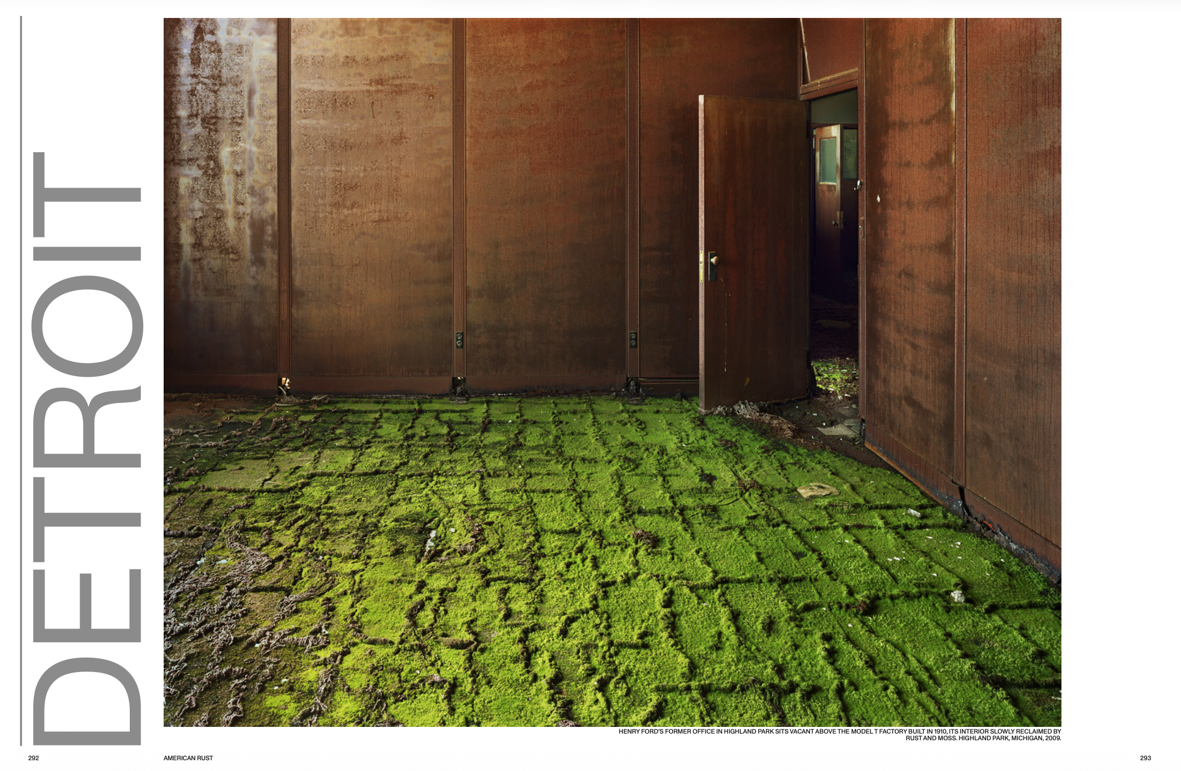 An abandoned building with rusted metal walls and a moss-covered brick floor, a partially open door revealing an interior.