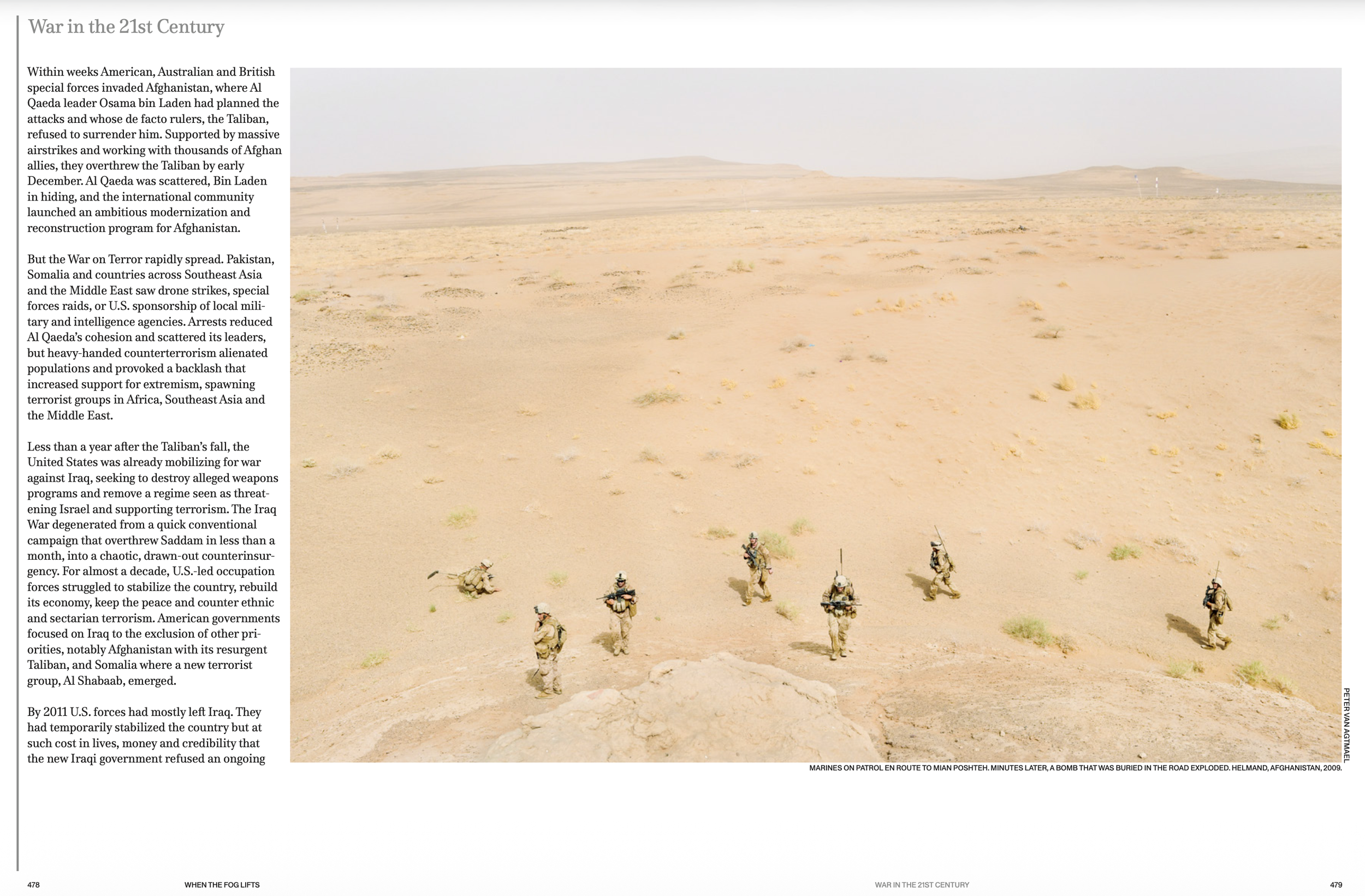 Marines on patrol in a desert landscape in Helmand, Afghanistan, with a planted bomb in the road