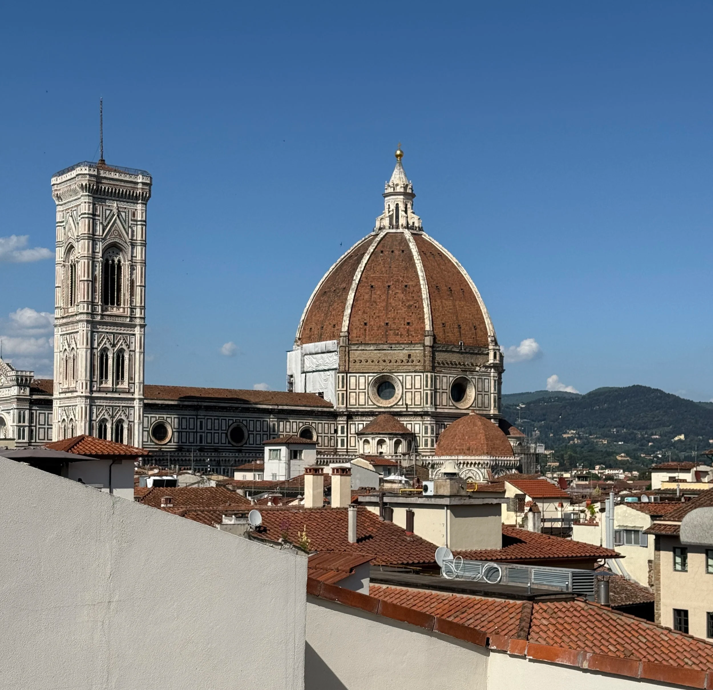 Rooftop view of Florence historic city centre, showcasing the Florence Cathedral and Filippo Brunelleschi’s iconic dome from a luxury hotel in Tuscany, one of Italy’s top travel destinations.