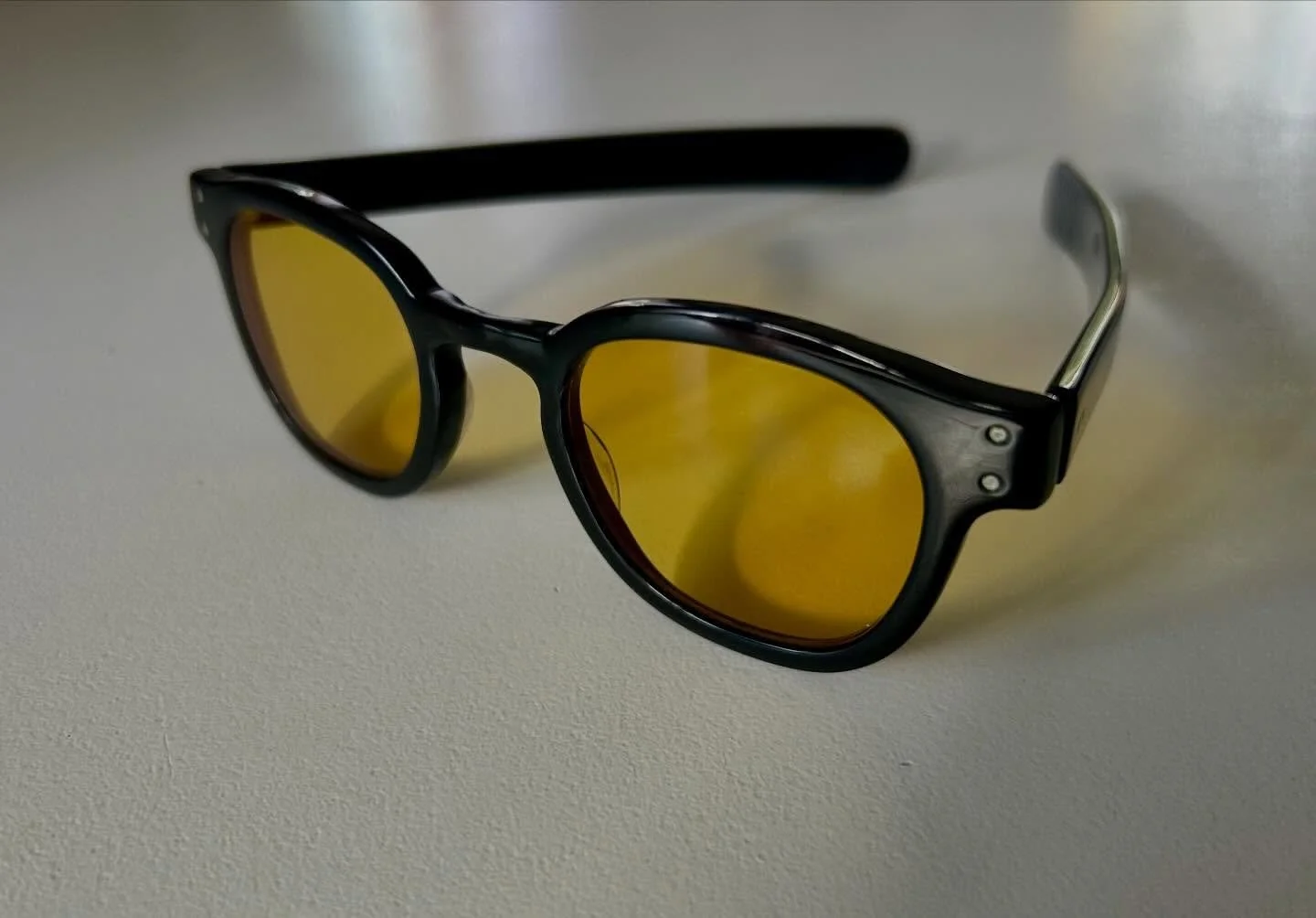 A vintage acetate frame brought back to life with acetate welding, rehydration, buffing and polishing, then finished with custom yellow lenses.