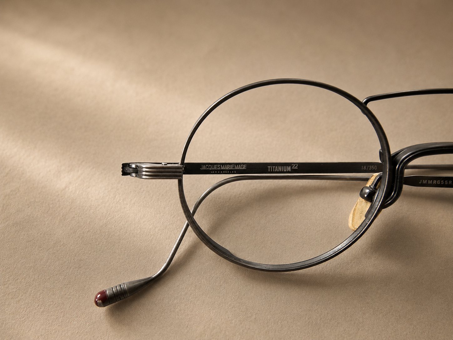 Broken metal glasses frame requiring precision welding repair and restoration.
