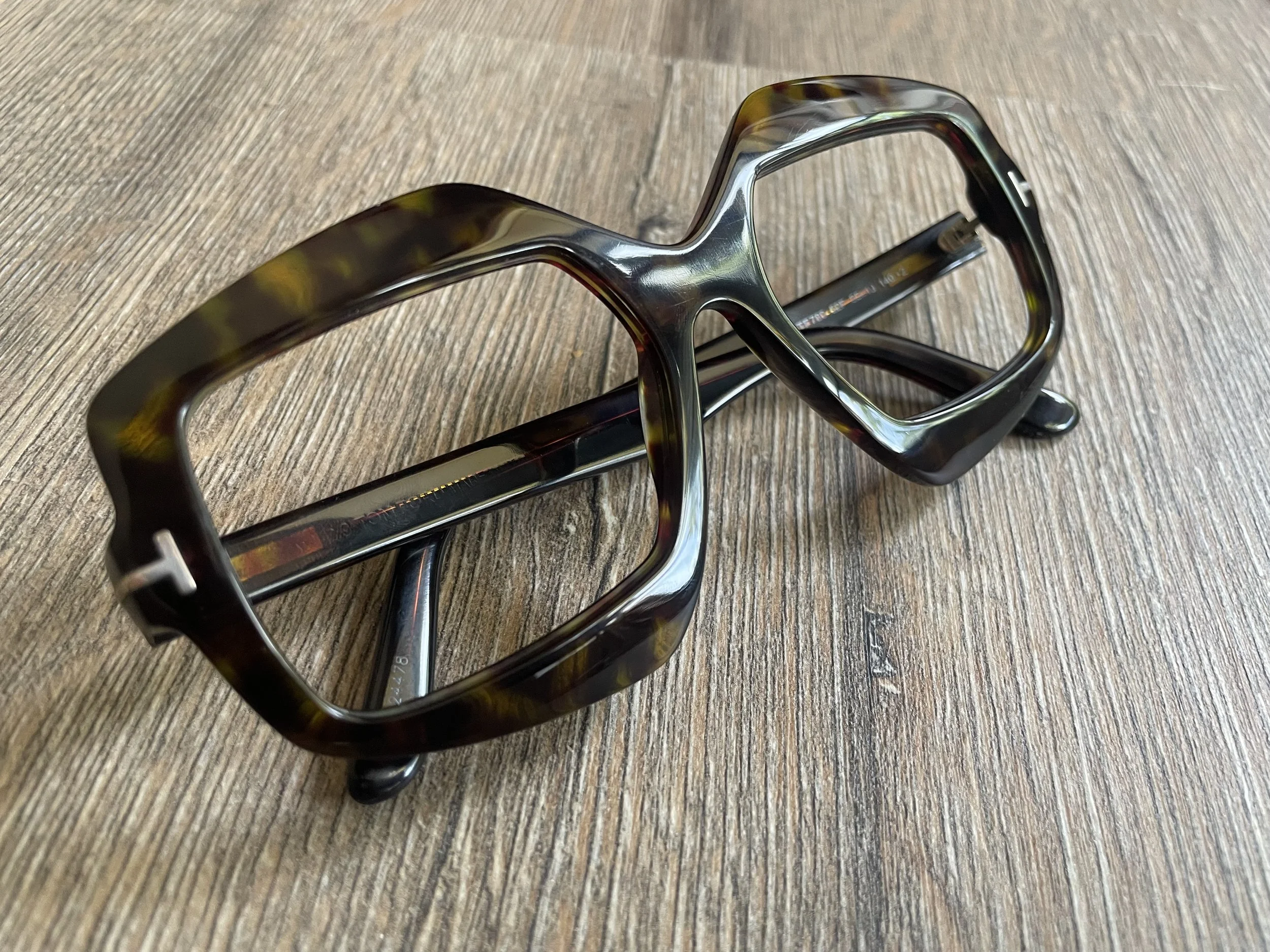 Professionally polished acetate glasses frame after refurbishment.