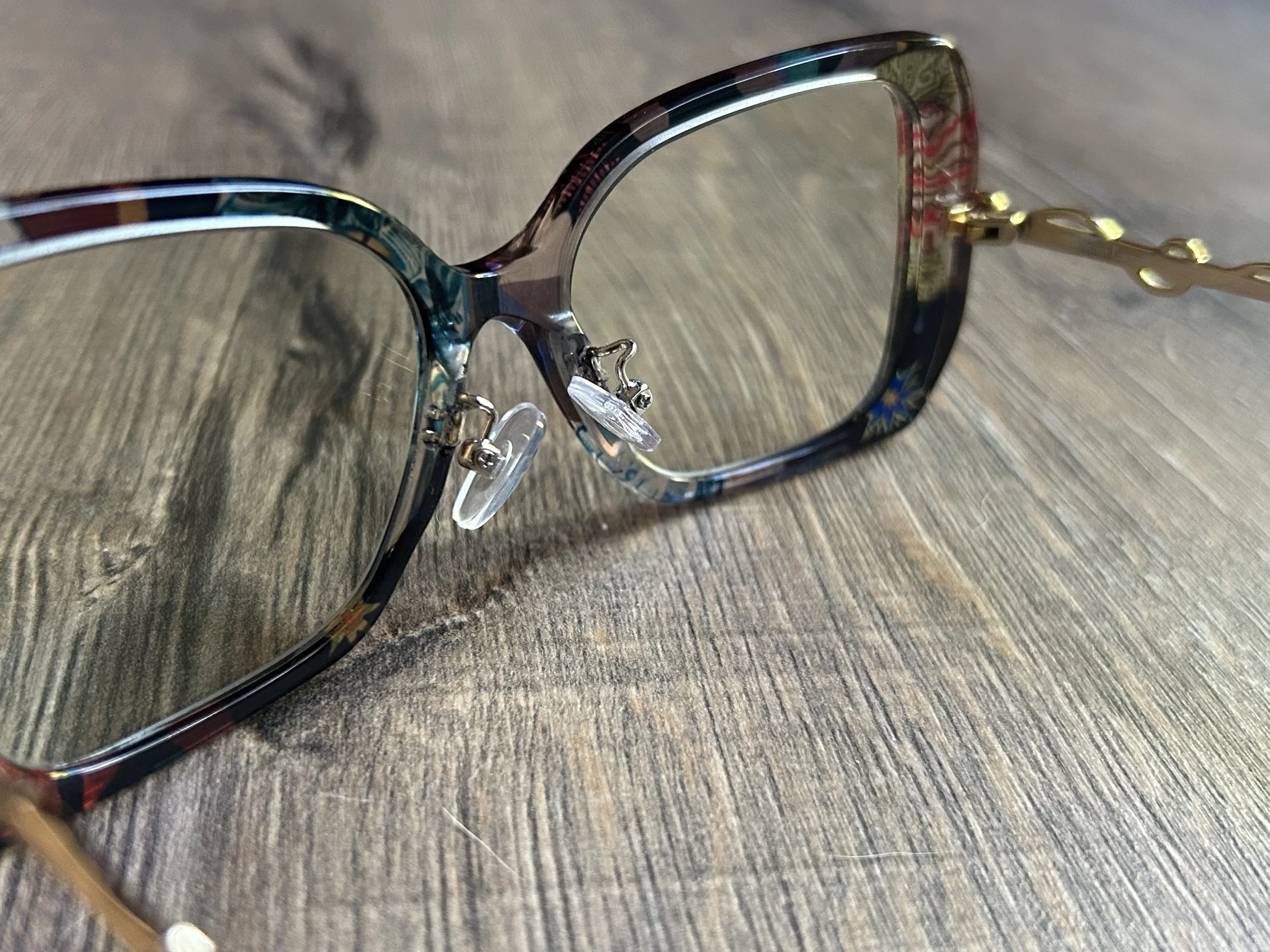 Nose pad arm installation on acetate glasses frame.