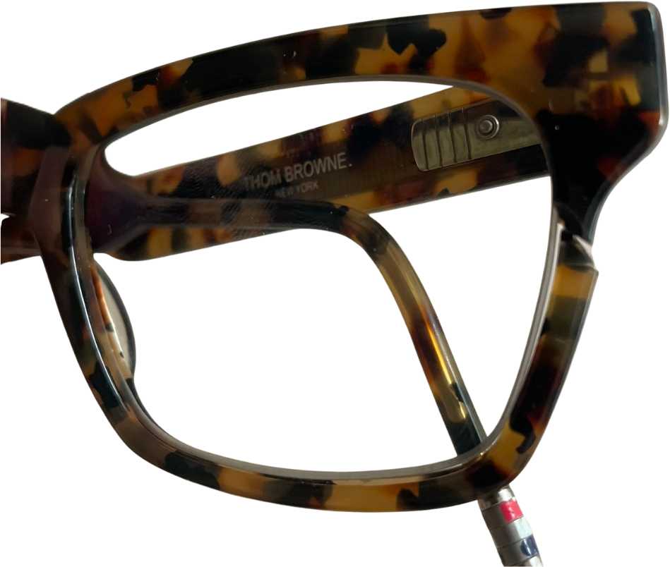 Cracked acetate glasses frame before professional repair.
