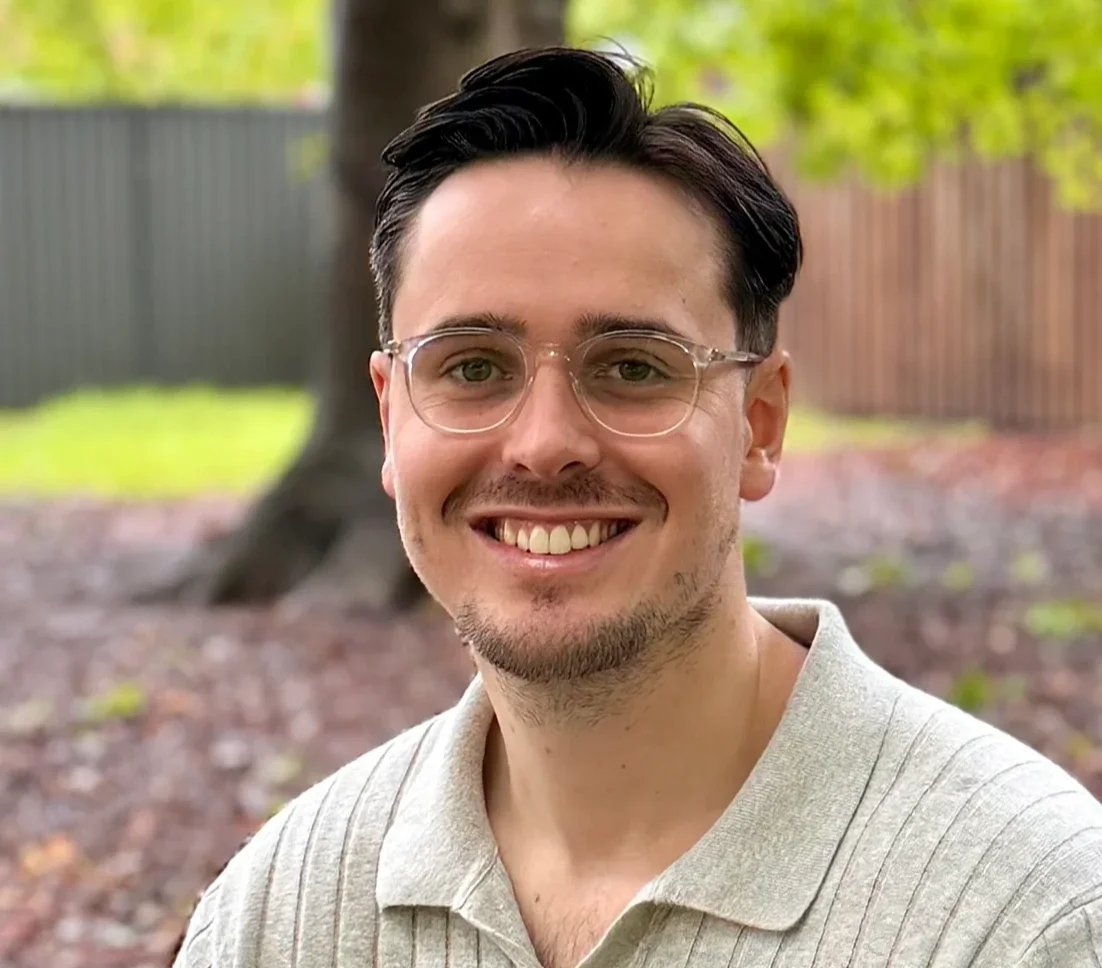 James Wightman, Gosford-based psychologist at MindSure Psychology, seated outdoors and smiling