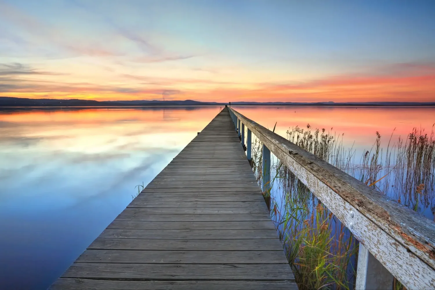 Calm Tuggerah jetty at sunset with still water on the Central Coast