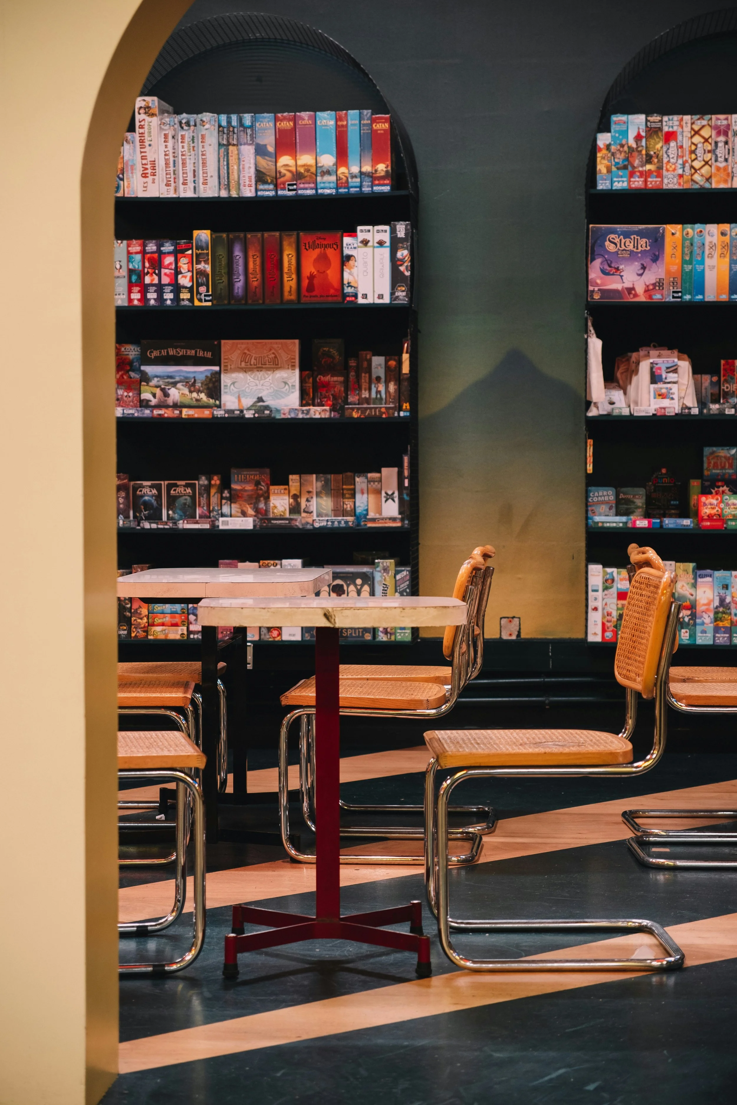 Board game shelf with popular titles like Catan and strategy games, used for tabletop and board game reviews.