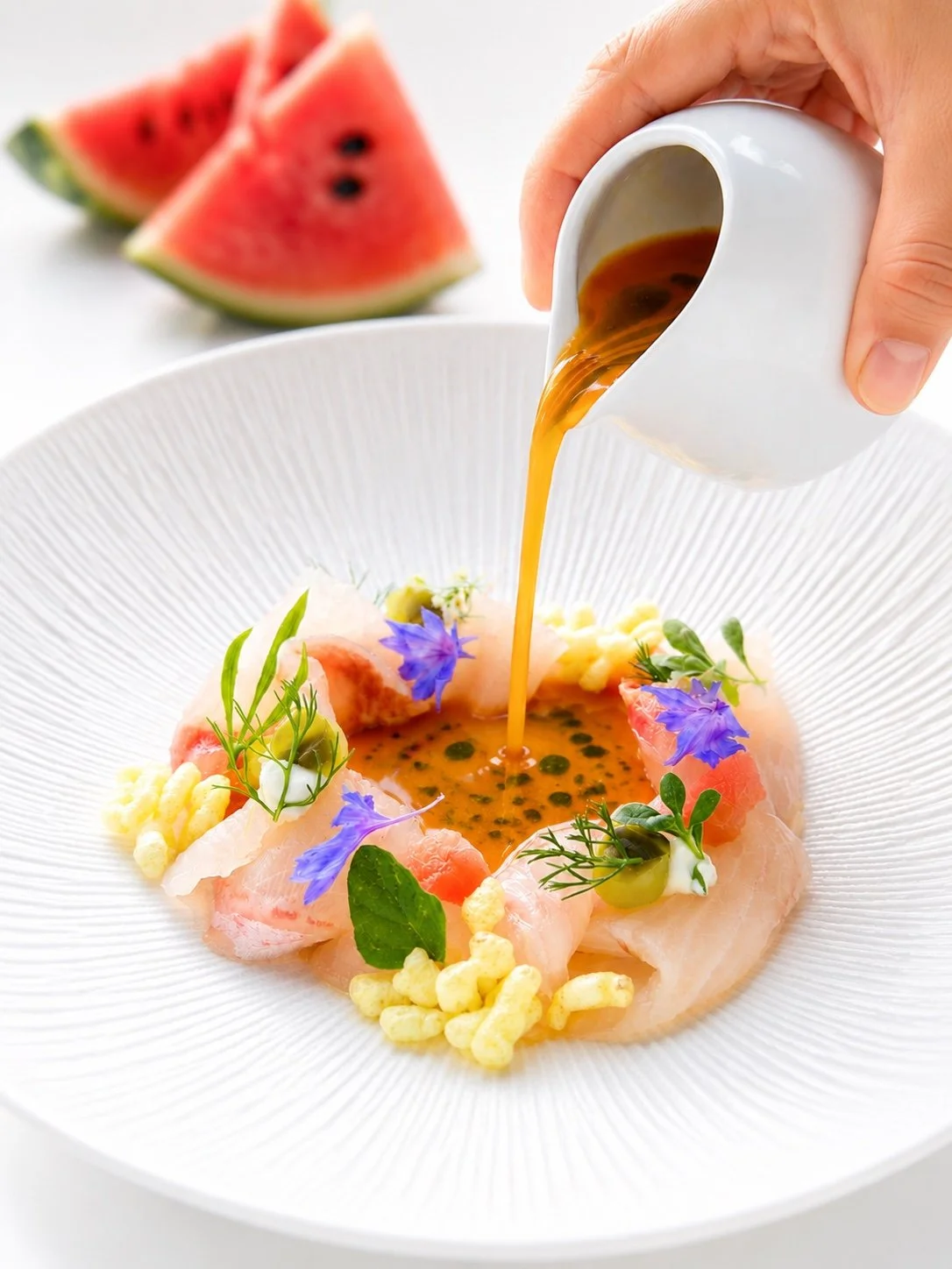 Carpaccio di ricciola, gazpacho di anguria, cetriolo candito e caprino