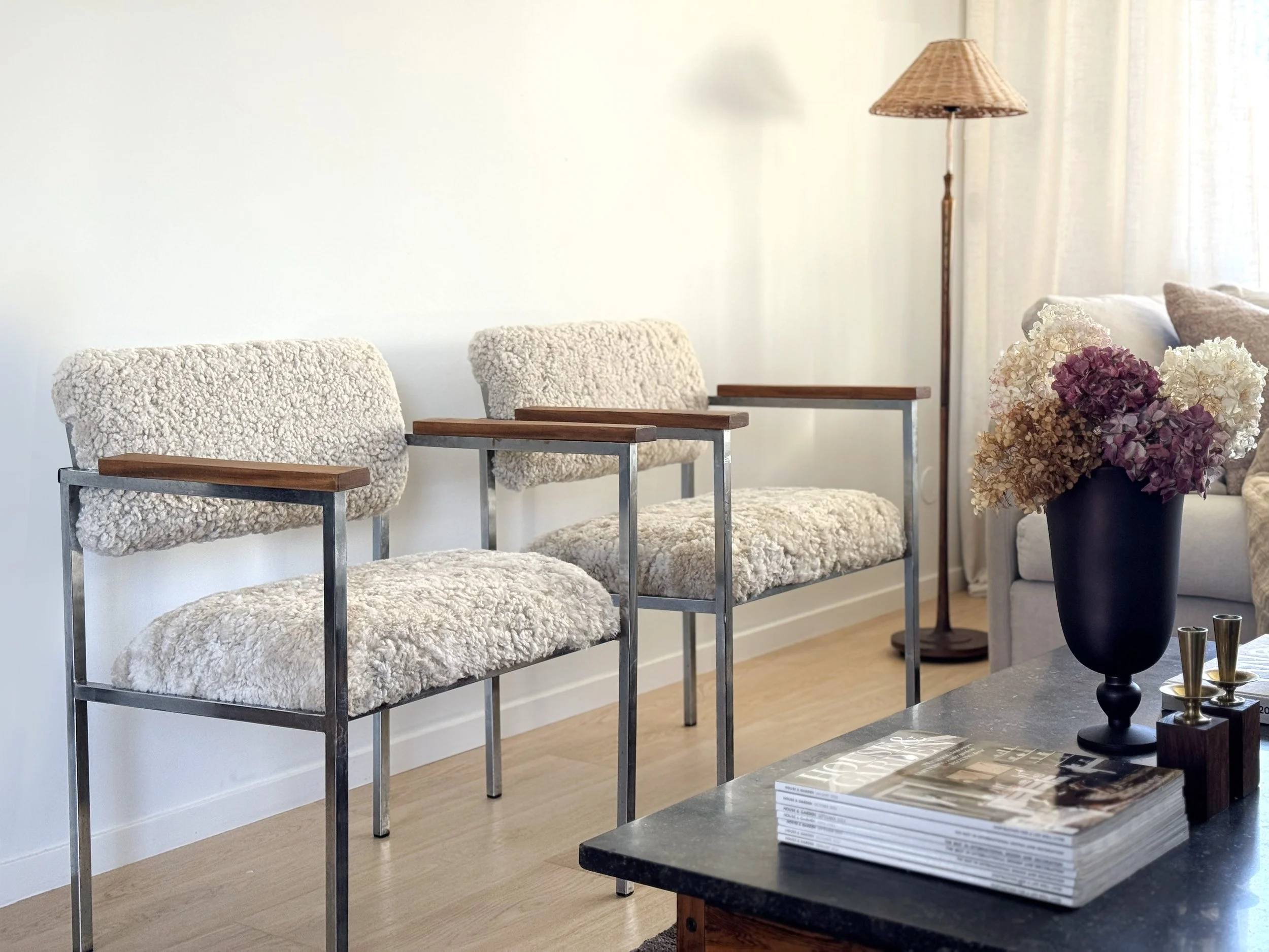 A Pair of Chrome chairs dressed in sheepskin