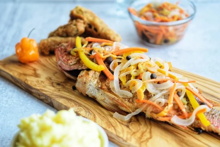 Crispy fried whole snapper topped with a vibrant escoveitch sauce of pickled carrots, onions, peppers, and fragrant spices—bright, zesty, and authentically Jamaican. Served with your choice of bases and sides.