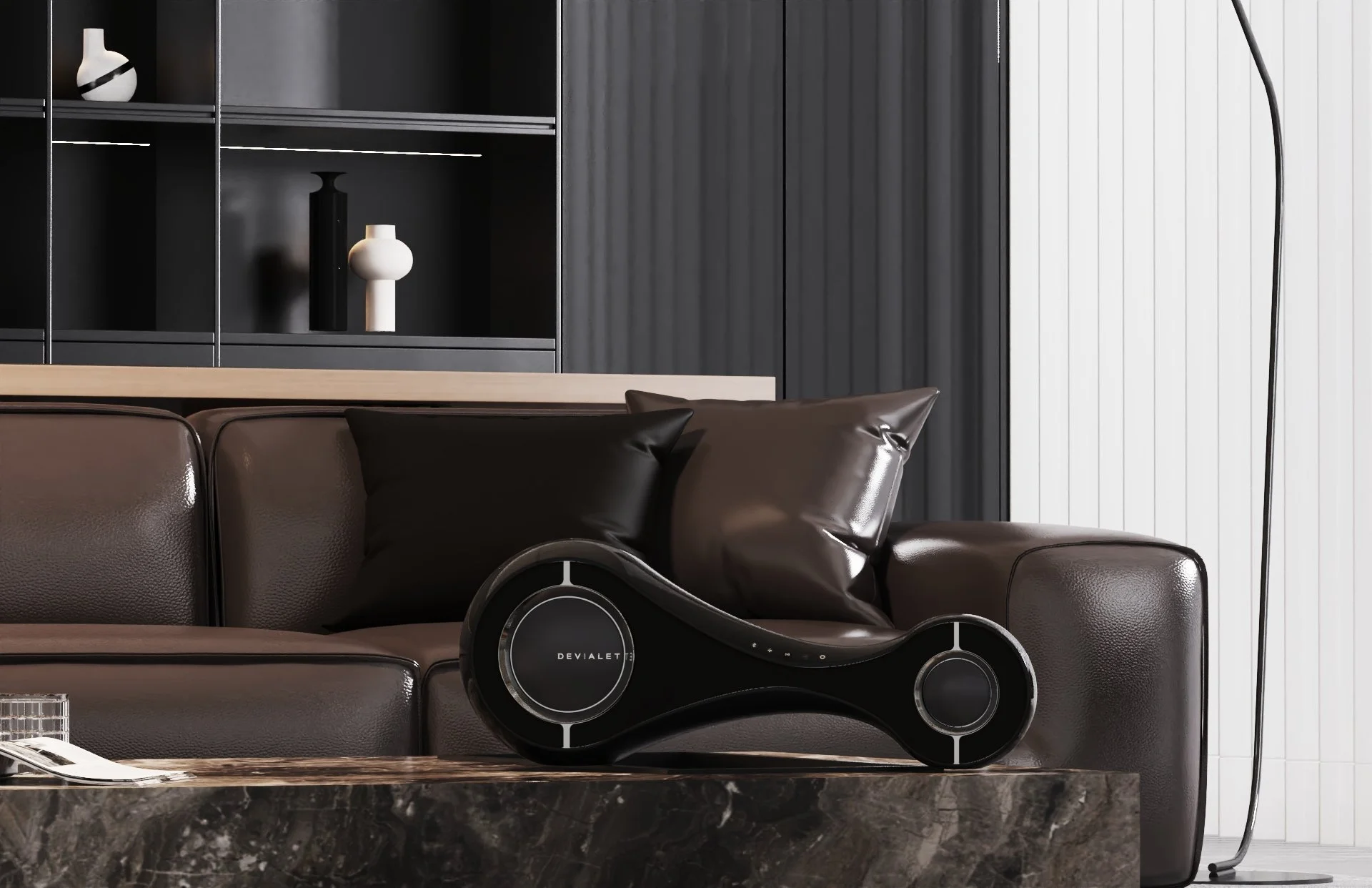 Modern living room with a dark brown leather sofa, black pillows, marble coffee table, black floor lamp, and dark shelving with decorative vases.