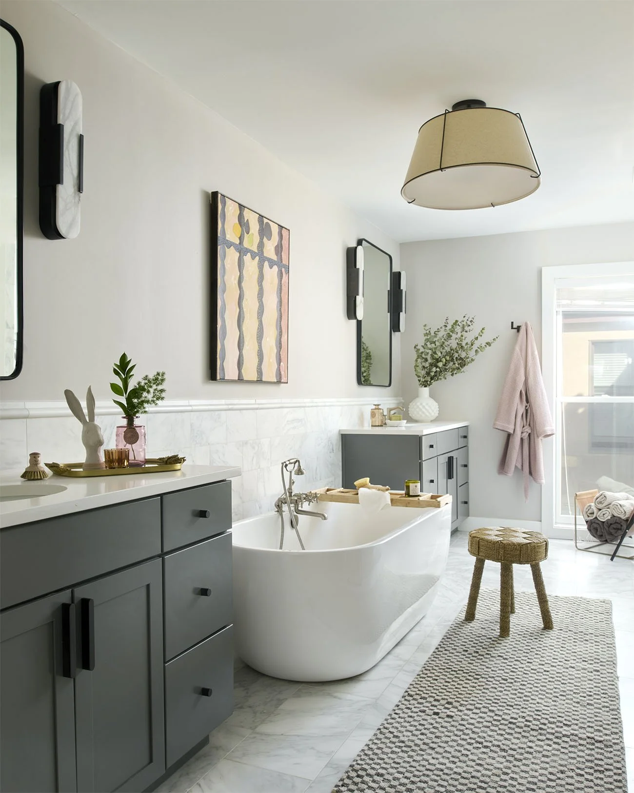 Light and airy bathroom featuring a soaking tub and hanging bathrobe