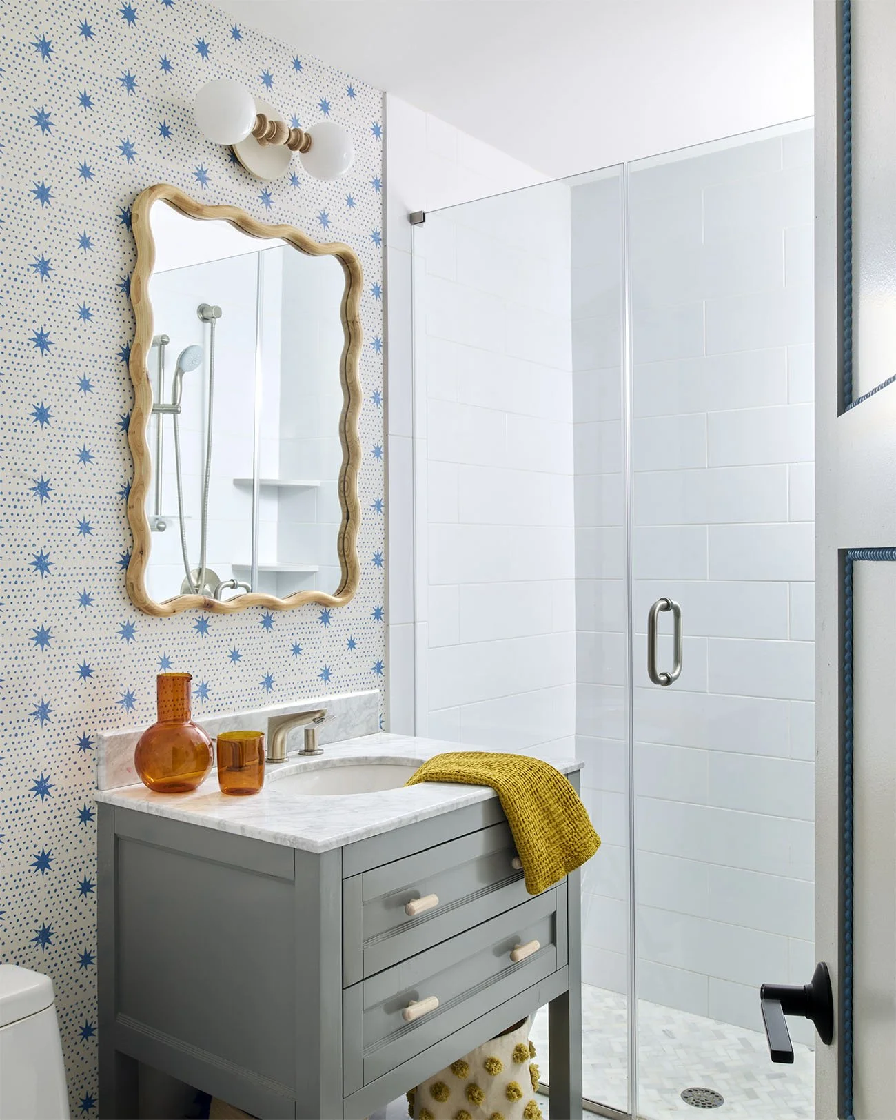 Bright and clean bathroom with mustard towel on the sink