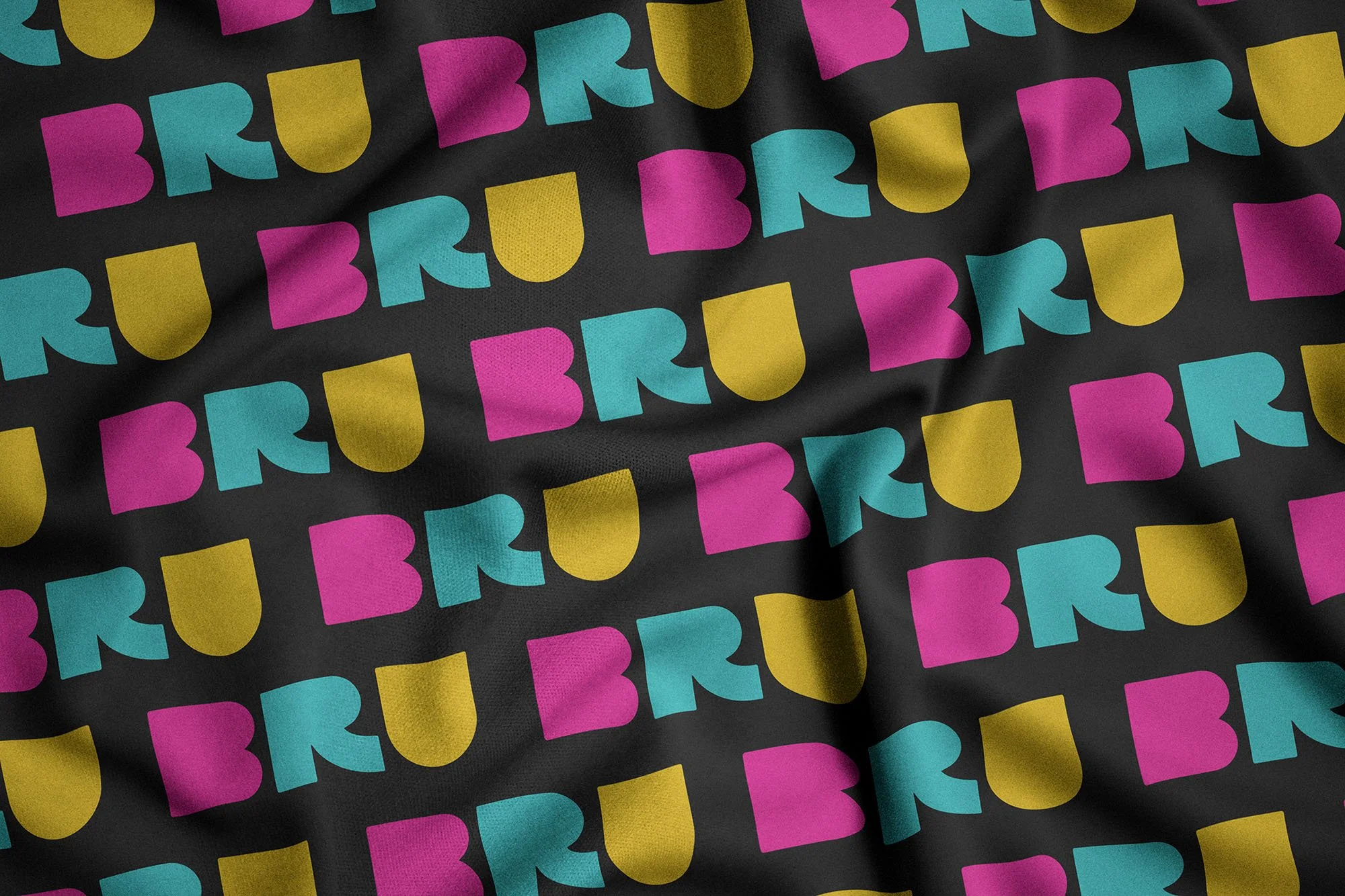 Colorful pattern of the BET logo in pink, blue, and yellow on a black background.
