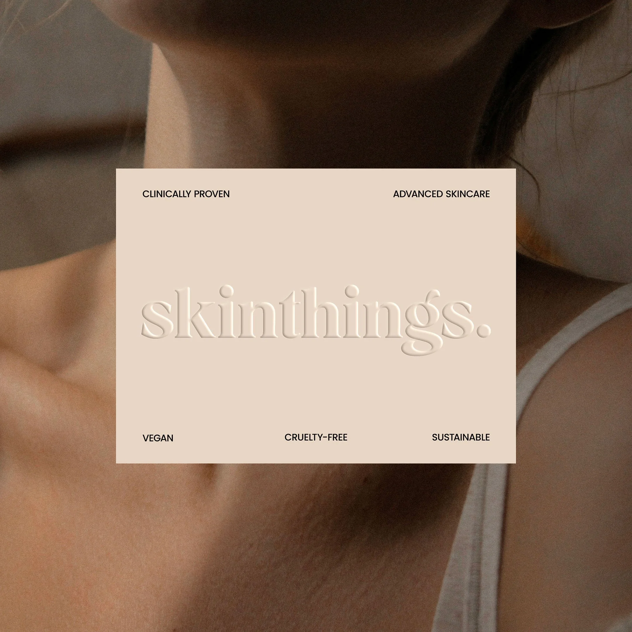 Close-up of a person's shoulder with a skincare product label overlay reading 'skinthings.' highlighting natural, cruelty-free, vegan, and sustainable skincare.