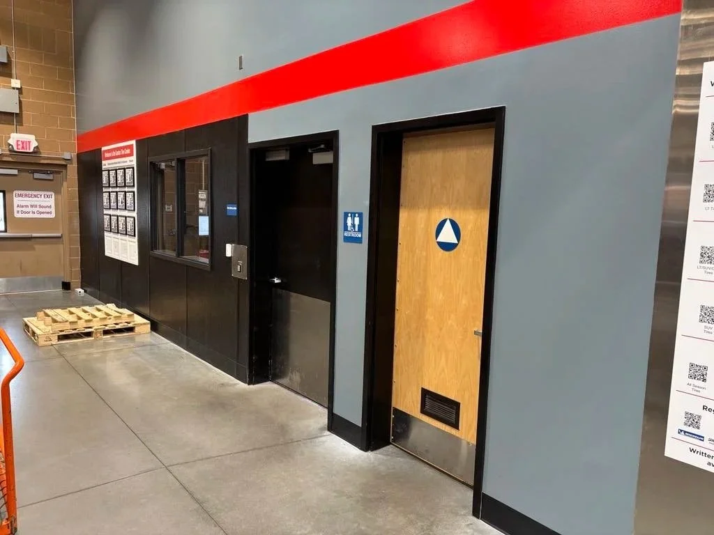 Finished Awards wall with red stripe and gray walls at the Traverse City Costco Tire Center