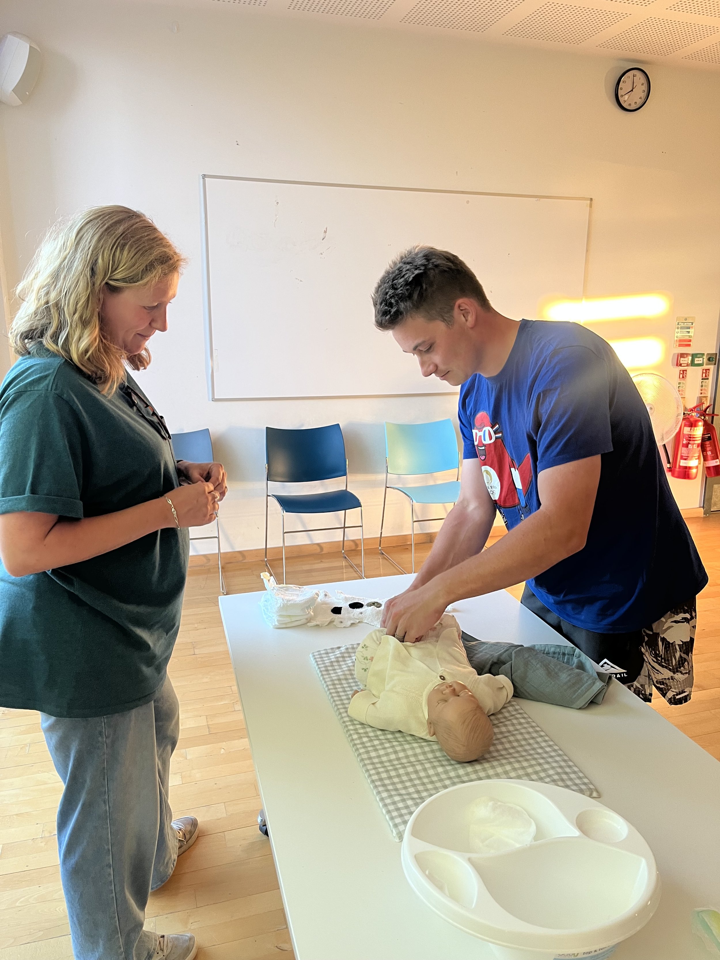 Expectant parents practicing nappy changes in Antenatal Classes in Bath