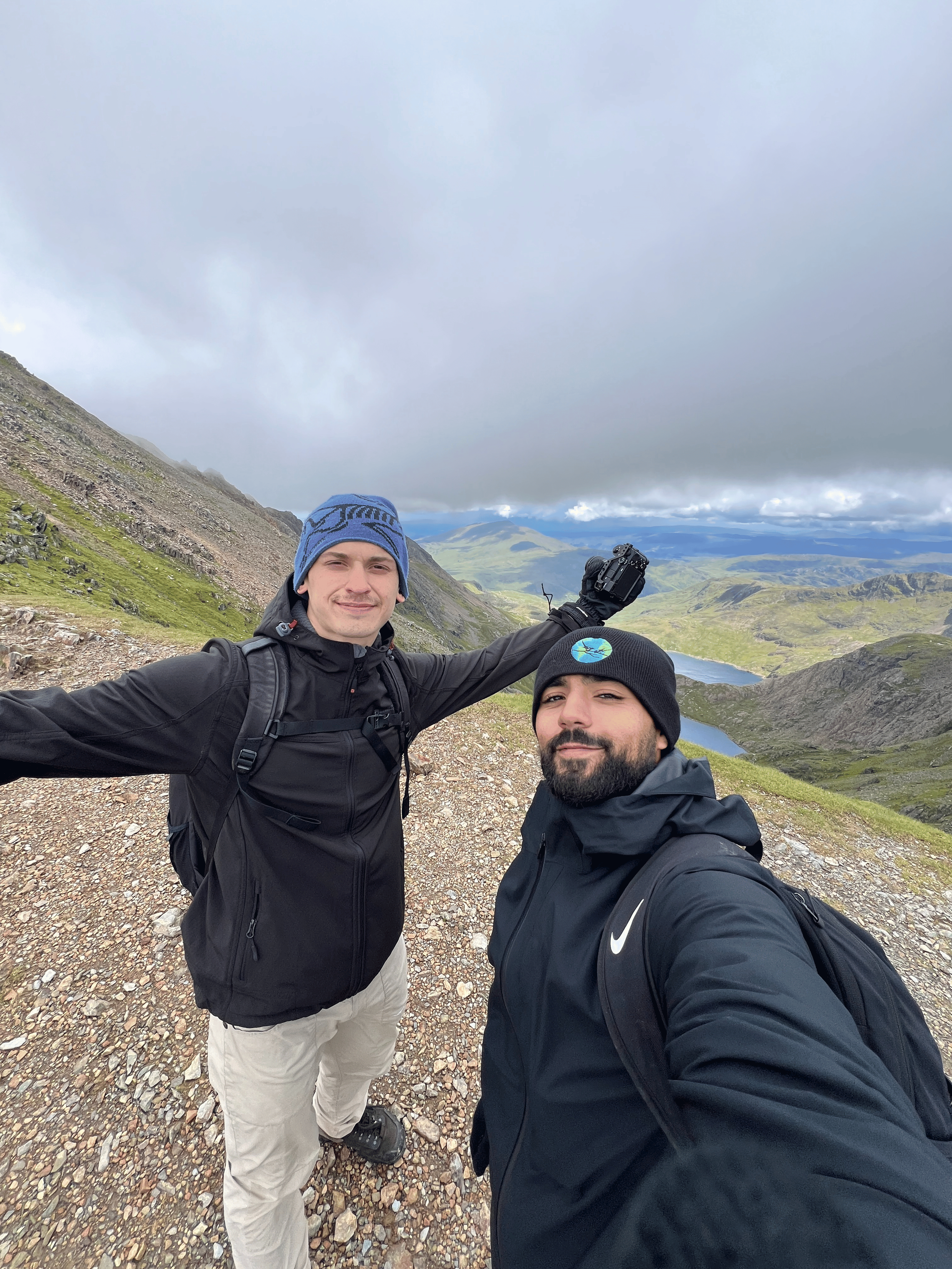 Rohan and Tom on a mountain trail during a Mission Planet journey, capturing a moment from an endurance-led mission
