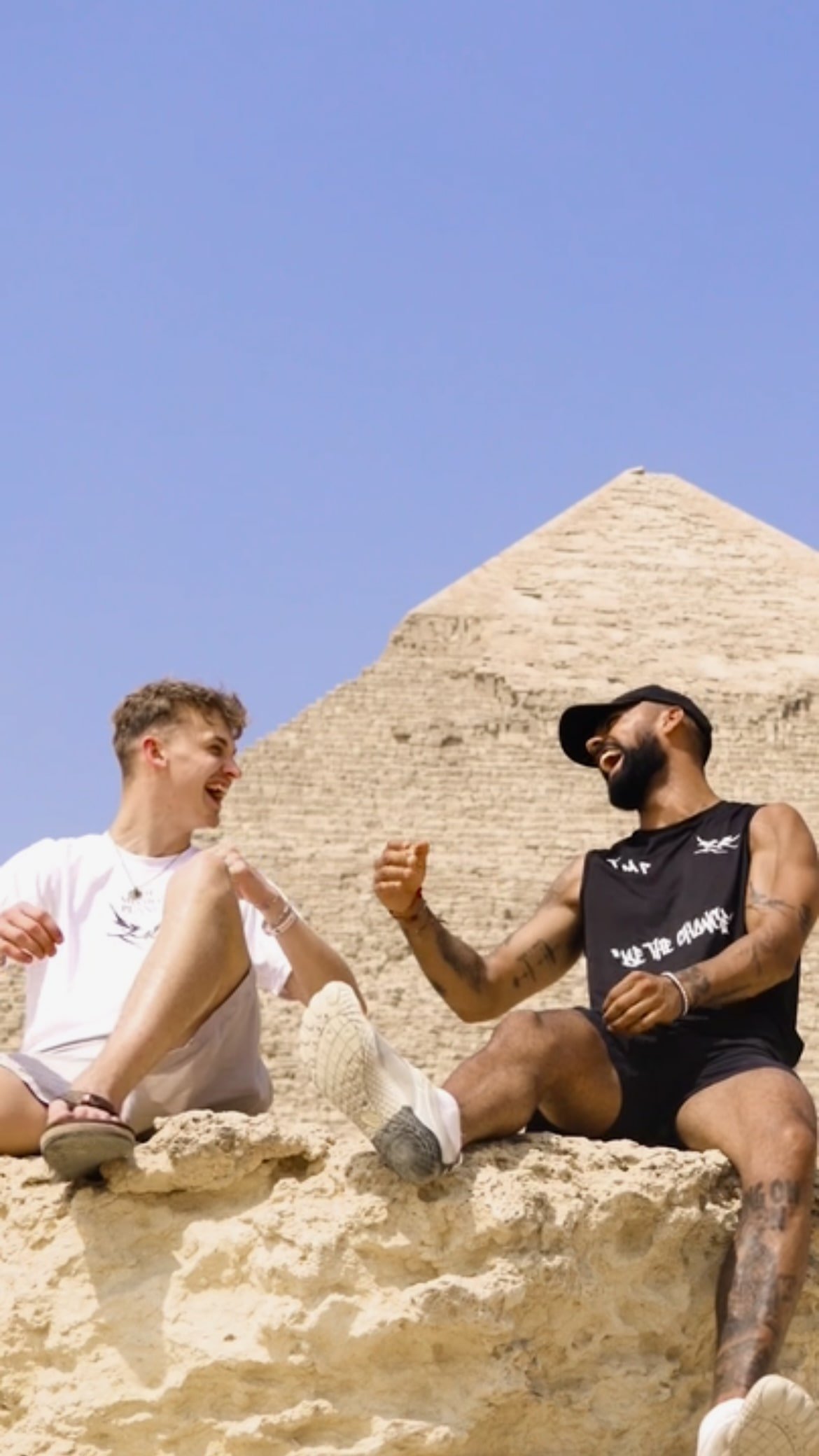 Rohan and Tom at the Great Pyramid of Giza during a Mission Planet journey, sharing a moment of connection while travelling