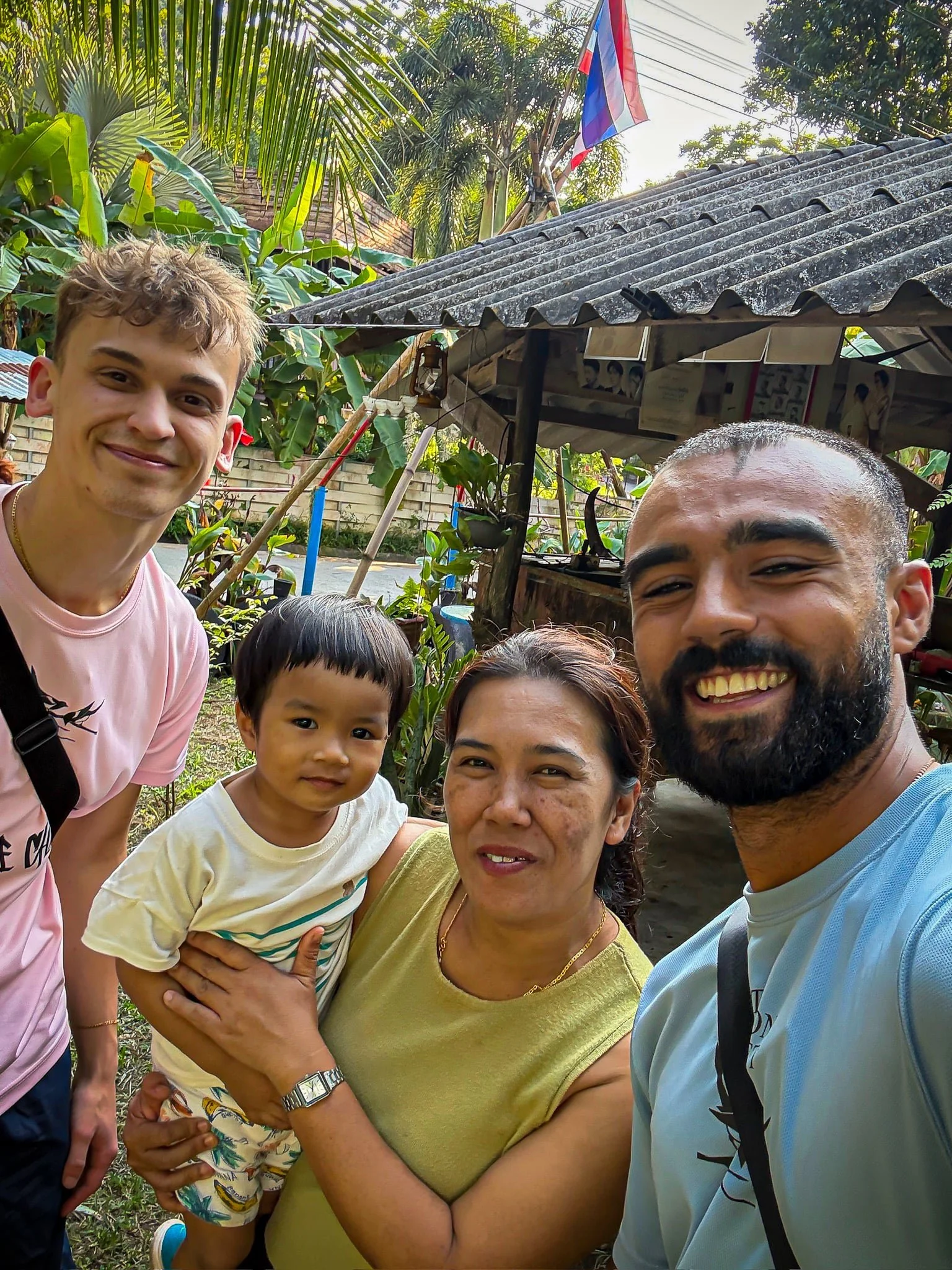 Rohan and Tom from The Mission Planet CIC with local community members during a visit supporting community-led initiatives.