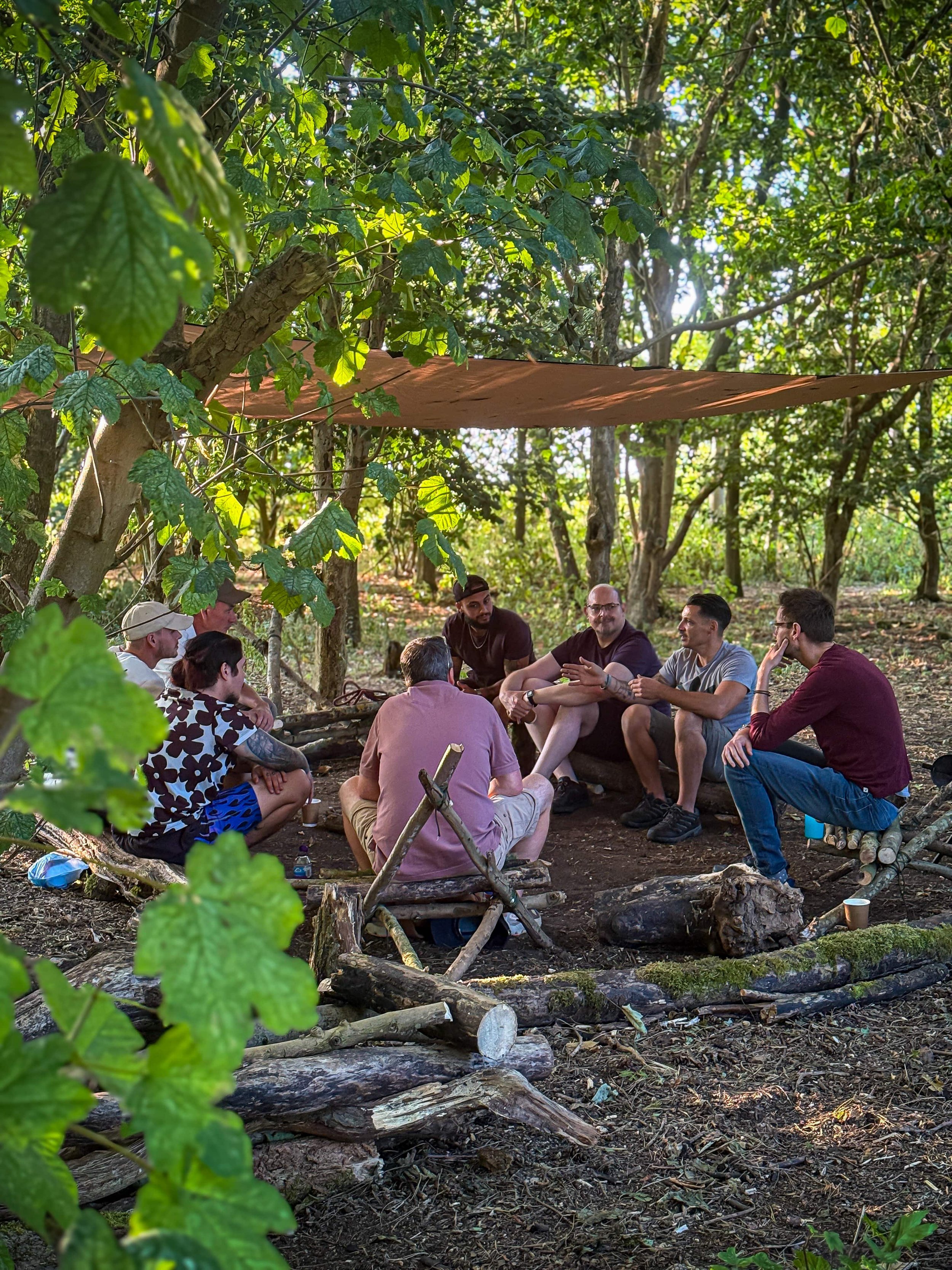 Members of The Mission Planet community taking part in a group discussion during an outdoor gathering.