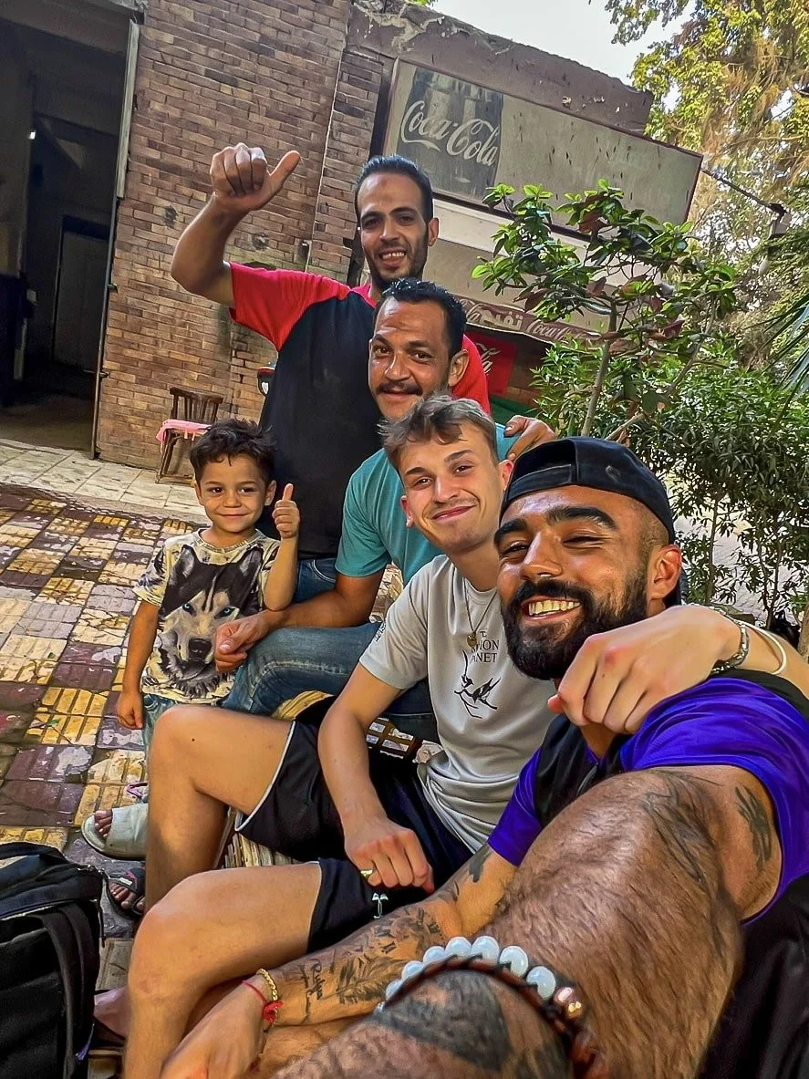 Rohan and Tom from The Mission Planet CIC with local community members in Egypt during a community visit.