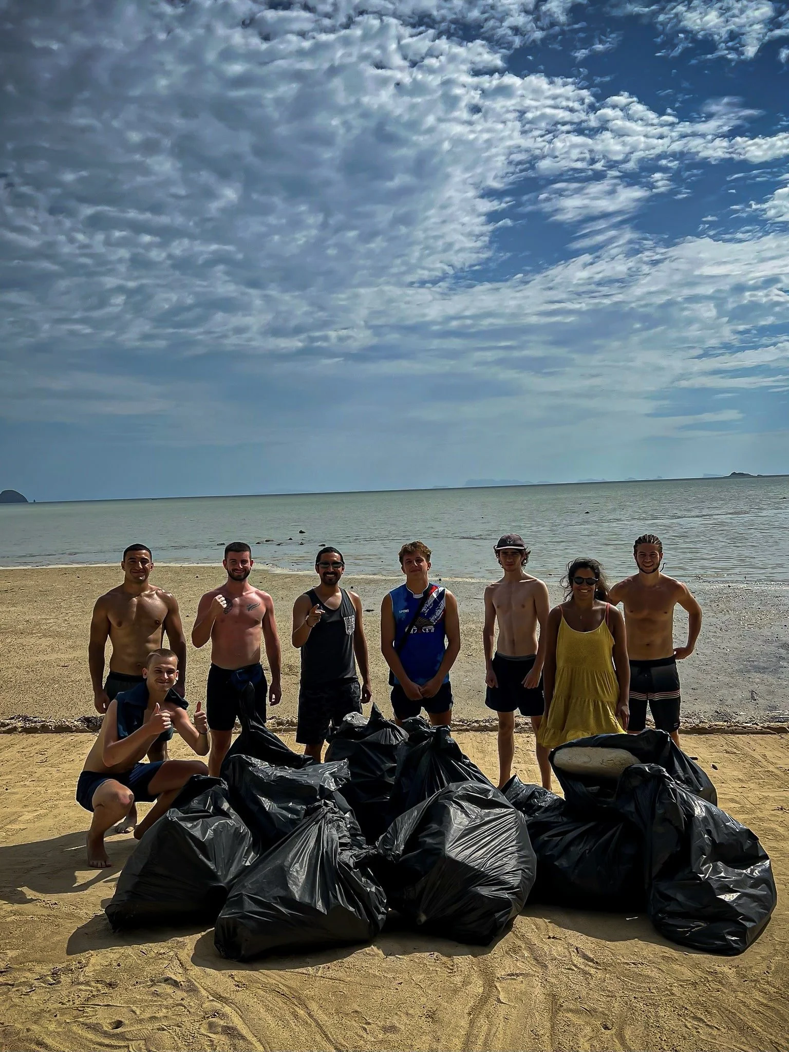 Rohan and Tom from The Mission Planet CIC with local volunteers during a beach clean-up initiative in Koh Phangan.
