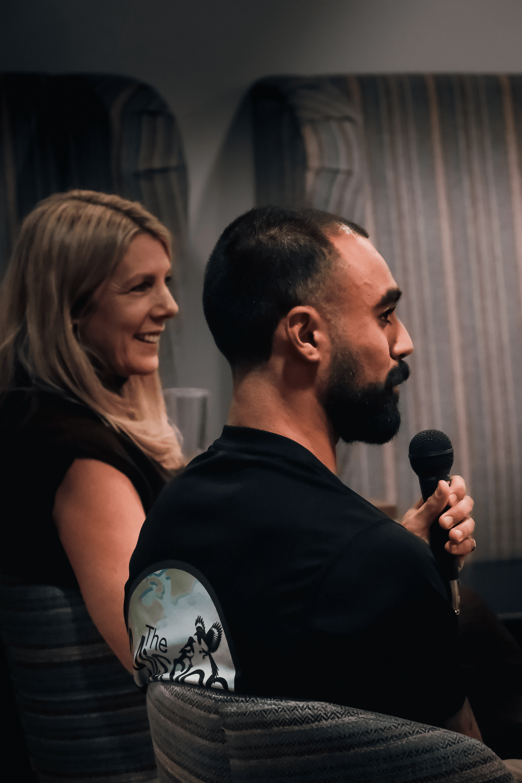 Rohan from The Mission Planet CIC speaking into a microphone during a talk about the organisation’s mission and community work.