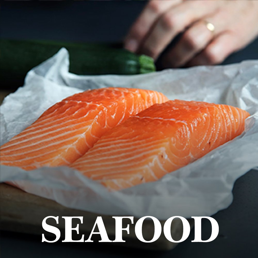 Two raw salmon filets on butcher paper