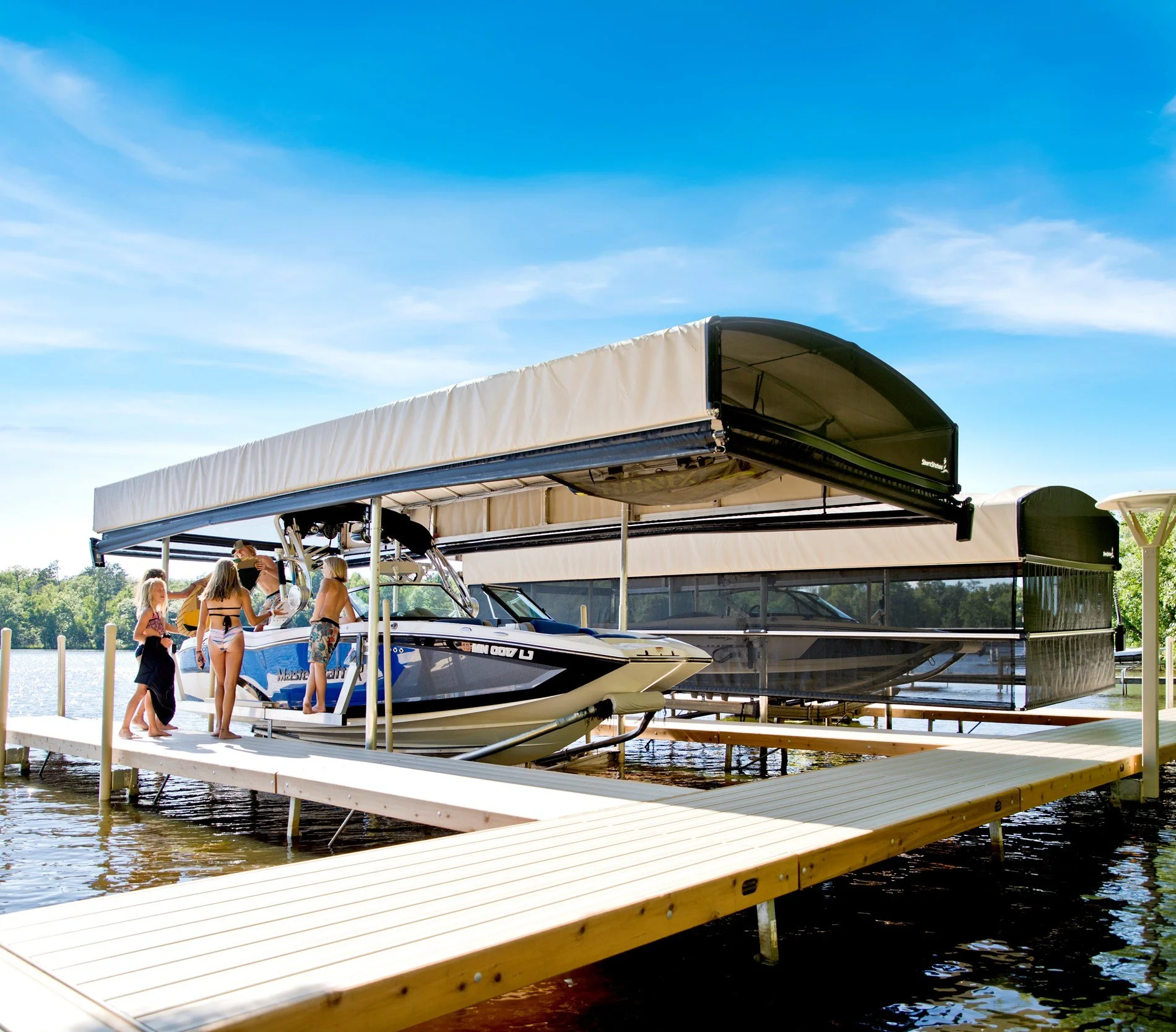 How do I choose between different brands of boat lifts for my waterfront property?