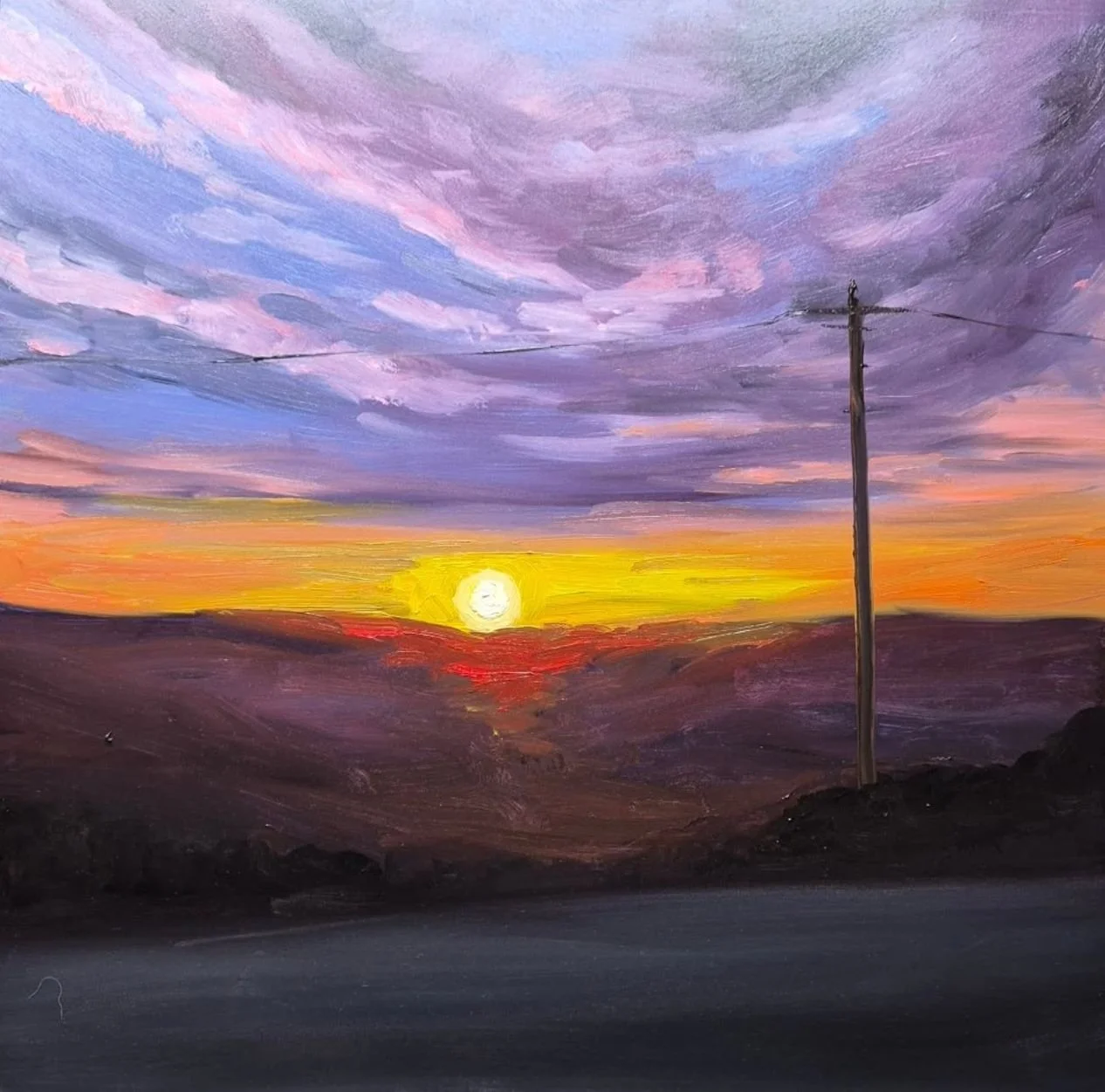 Painting of a sunset with colorful clouds in purple, pink, blue, and orange, a bright yellow sun near the horizon, dark rolling hills, a telephone pole with power lines on the right, and a dark road in the foreground.