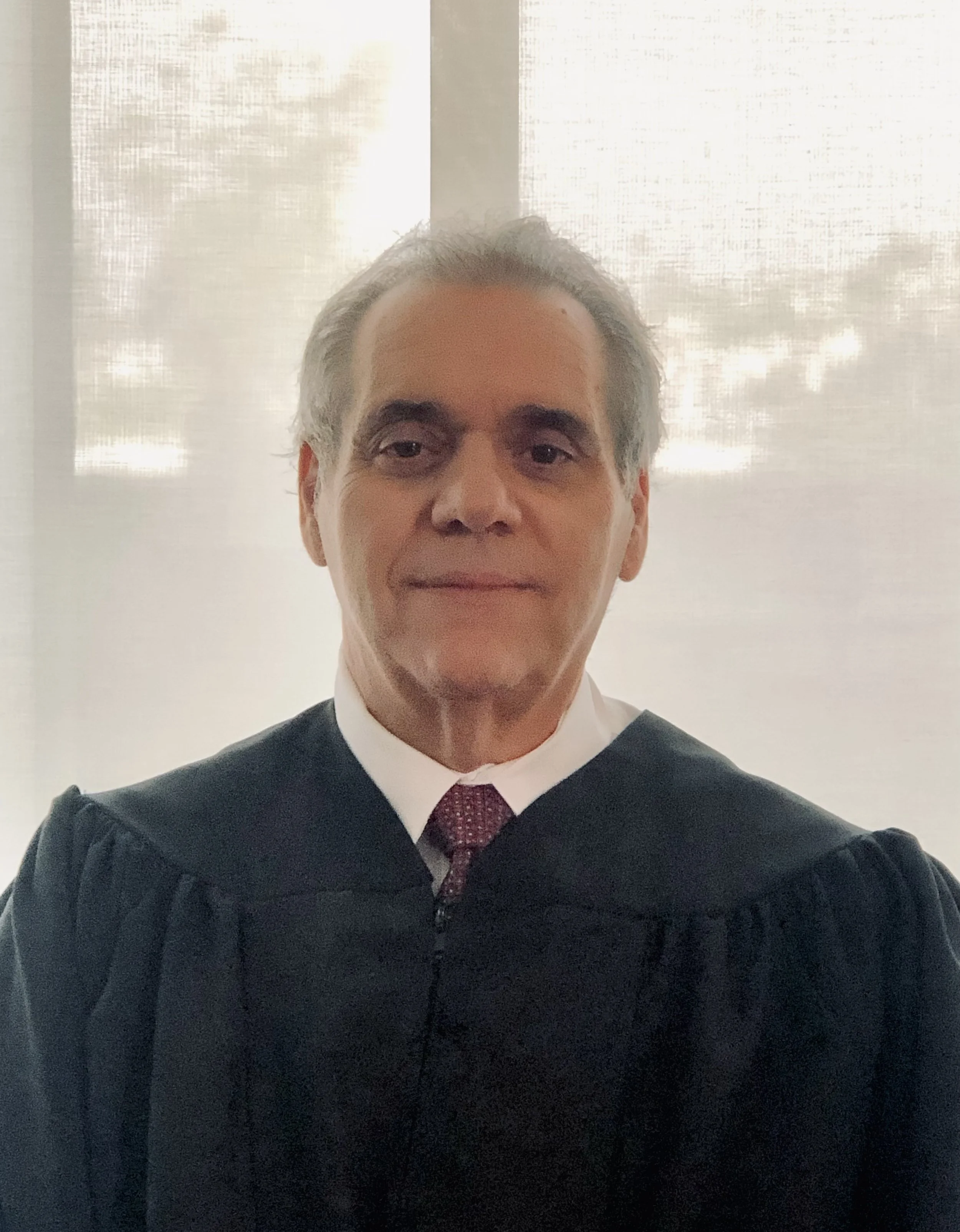 Judge Philip A. Tornetta in his Judge robes, sitting in a court room.