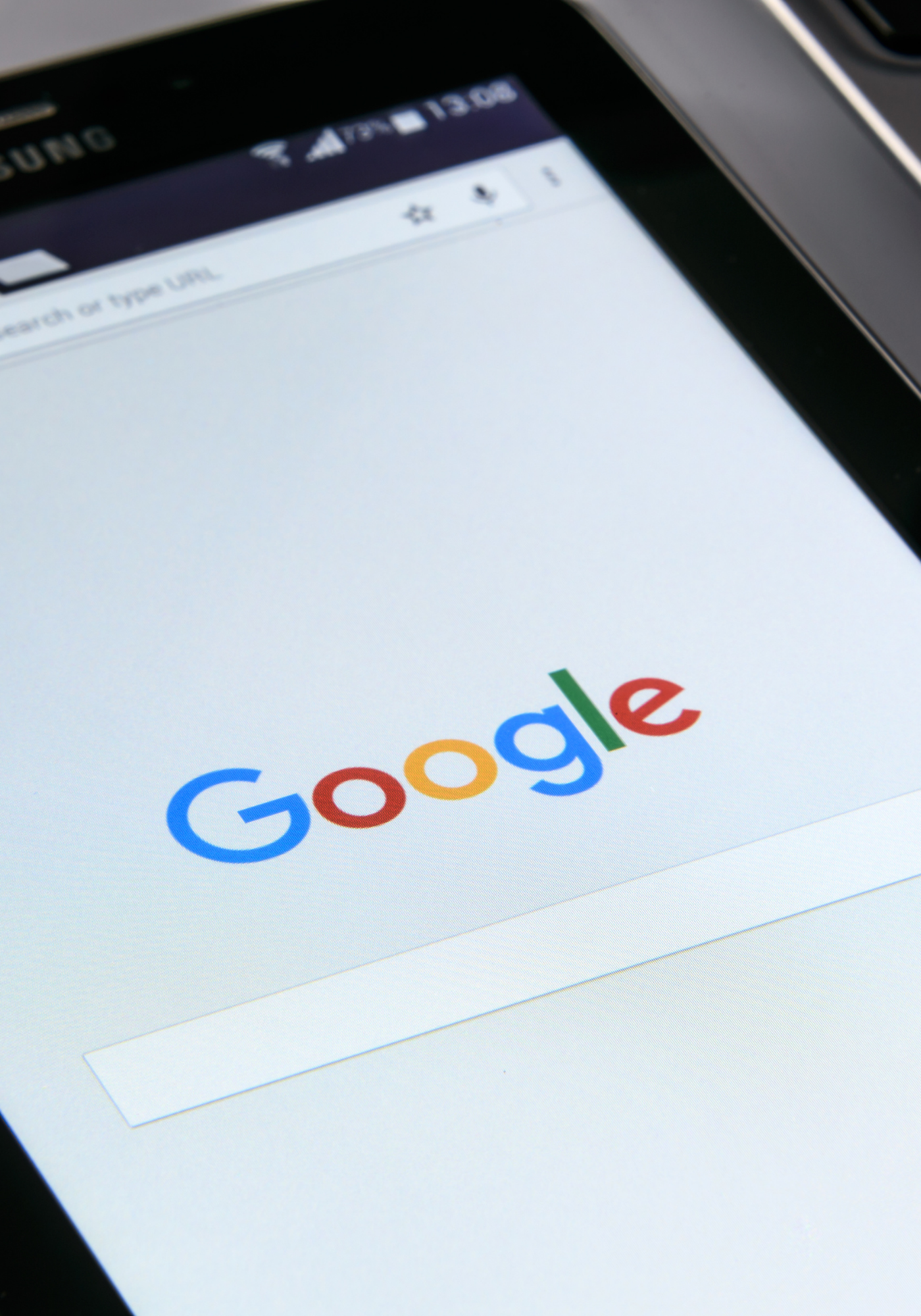 Smartphone screen displaying the Google search homepage.