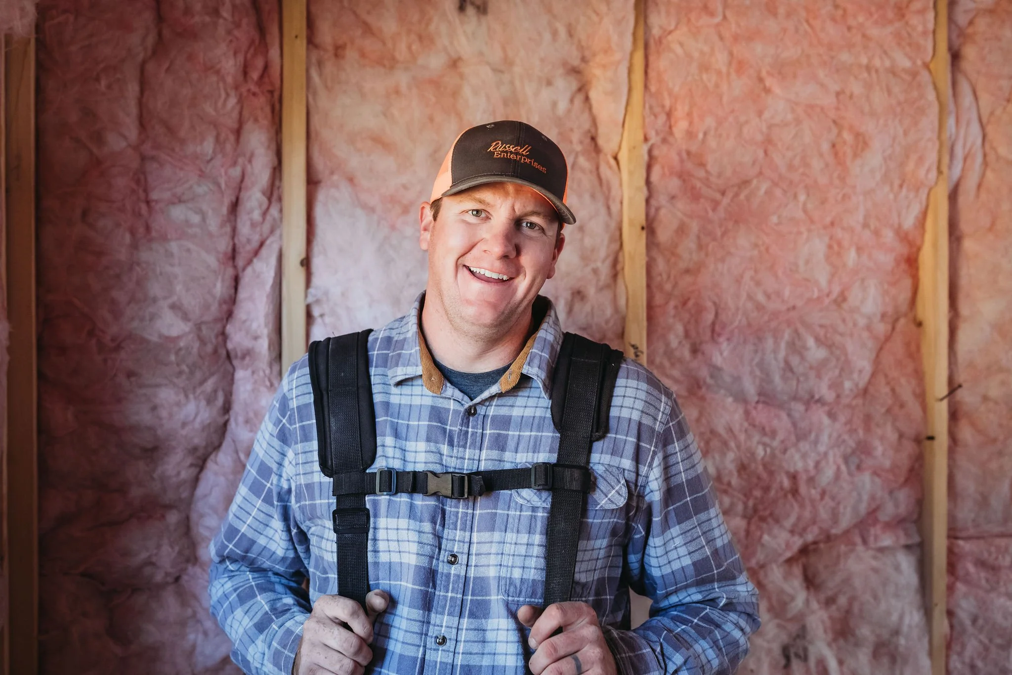 Josh Russell on site during a residential home renovation, overseeing insulation and construction work.