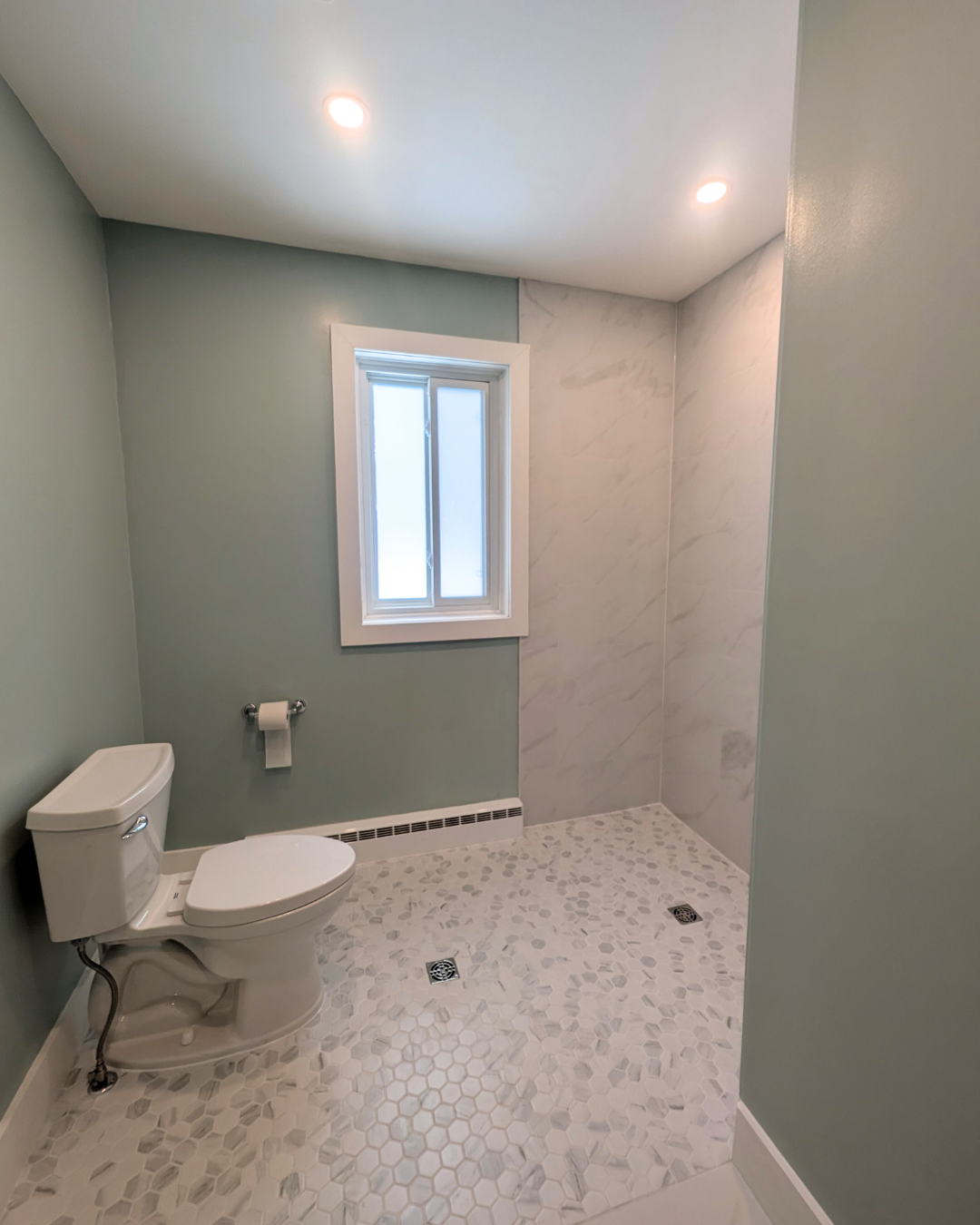 Barrier-free bathroom renovation with a walk-in shower, accessible layout, and clean, modern finishes.