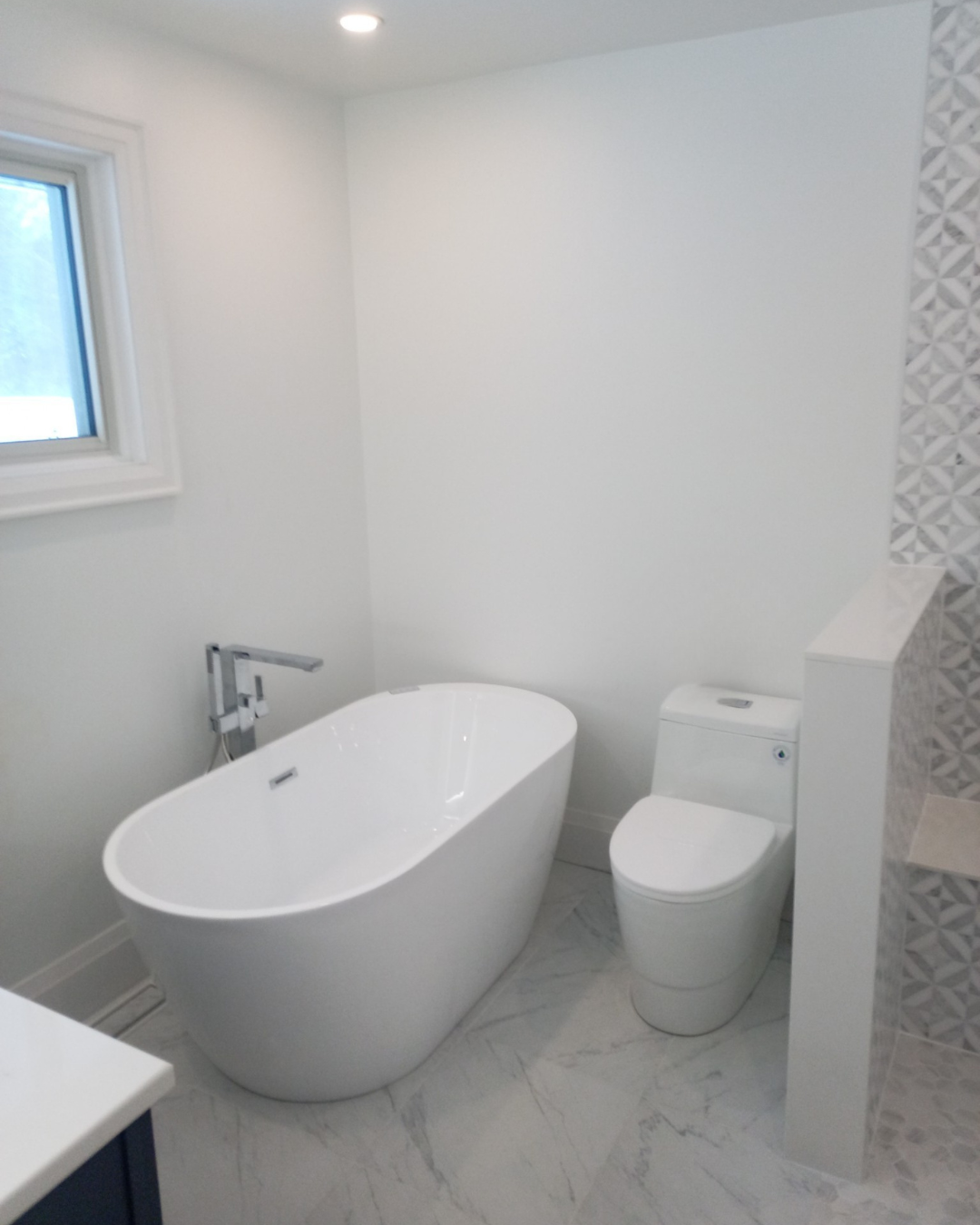Custom bathroom renovation featuring a walk-in shower, freestanding soaker tub, and modern finishes.