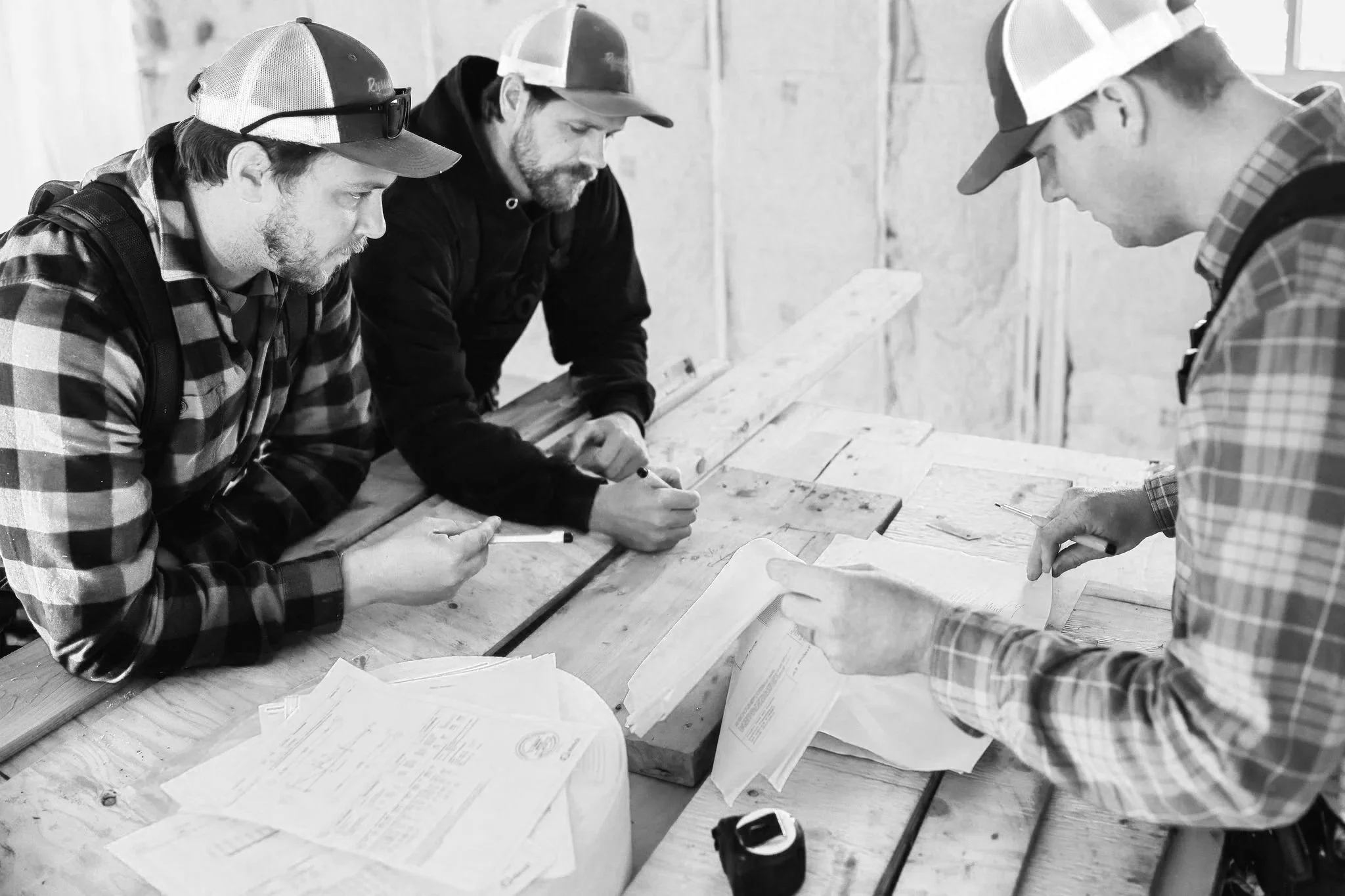 The Russell Enterprises team reviewing plans and discussing a residential construction project before work begins.