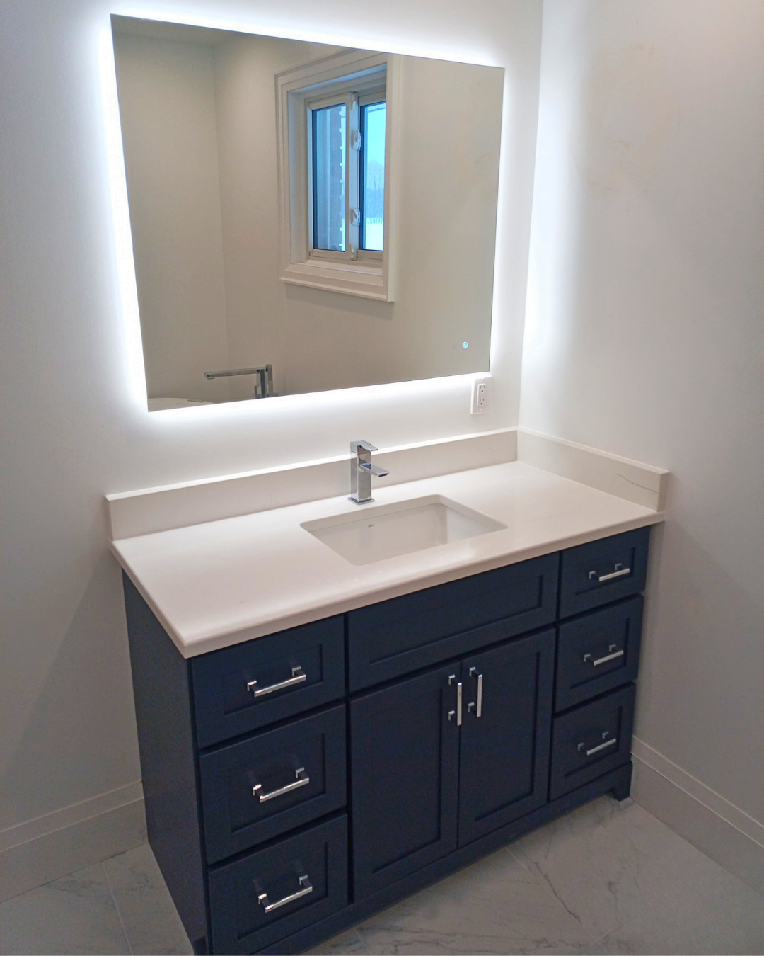 Modern bathroom vanity with custom cabinetry, integrated lighting, and a sleek contemporary design.