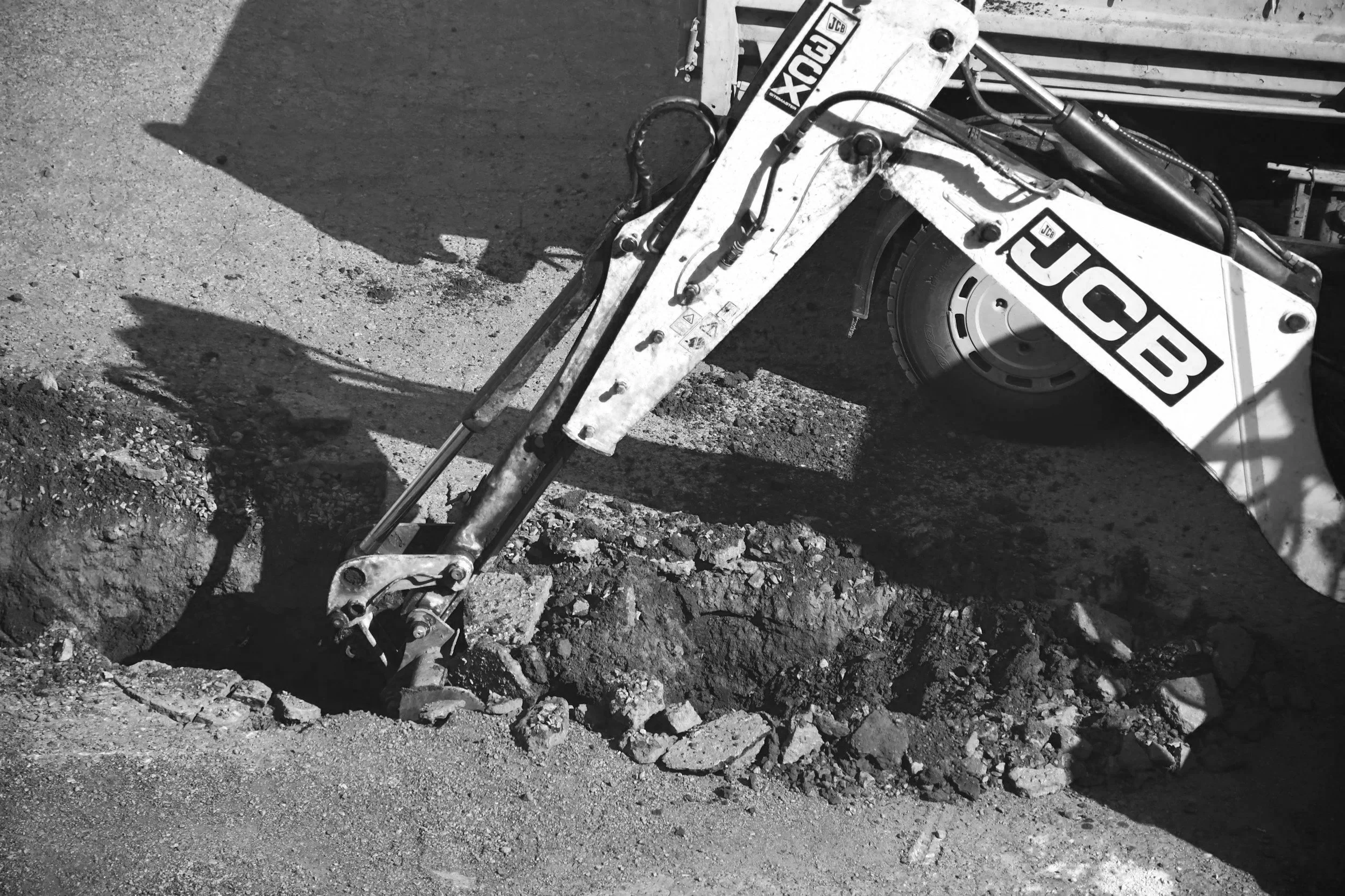 Mini excavator trenching for residential site preparation before construction begins.