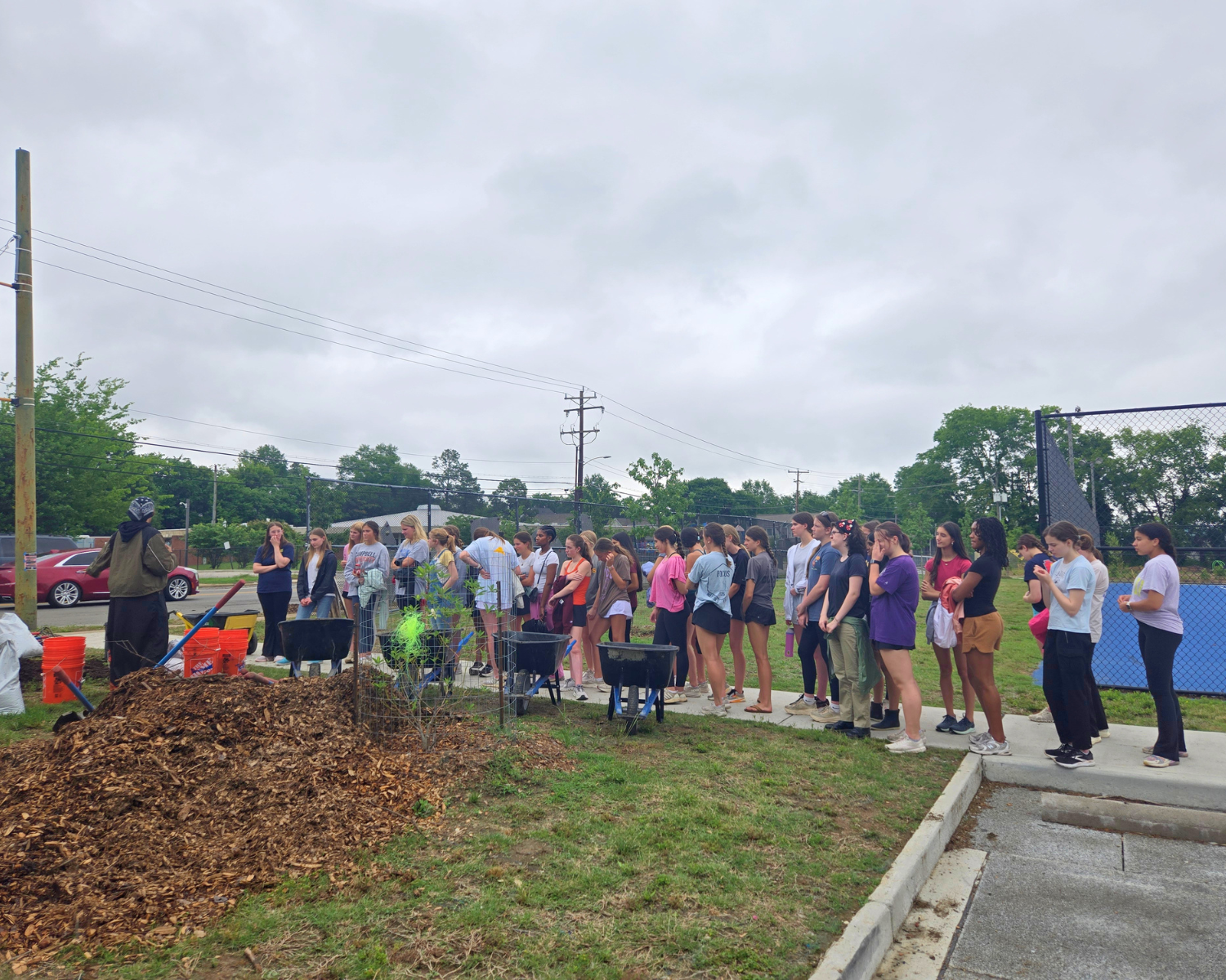 Students listen to instructions from Syd Collier of Southside ReLeaf before they start planting.