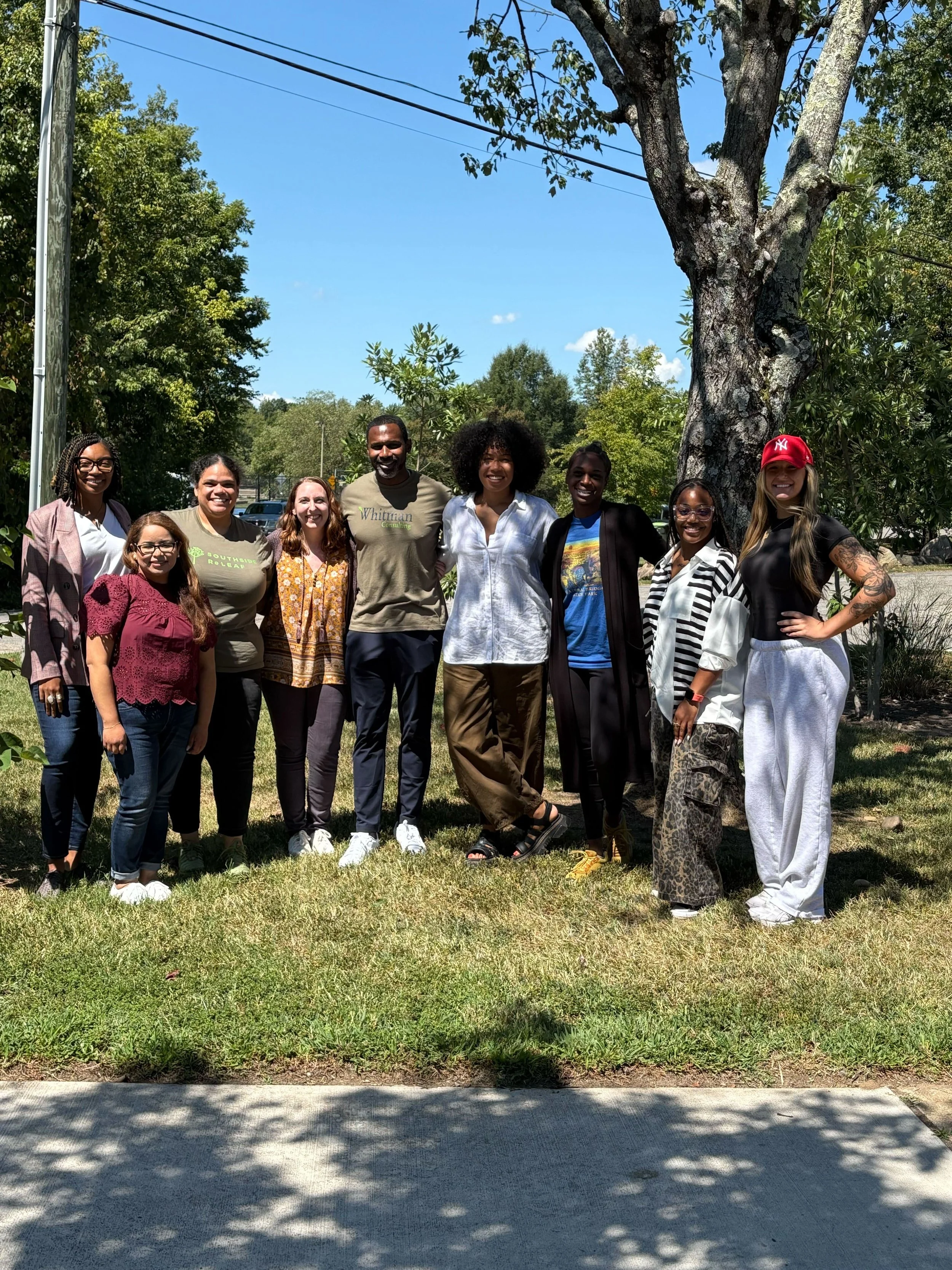 Team photos of Southside ReLeaf taken under the shade of a mature tree at Broad Rock Library. The photo also includes Andre Thornton, who was guiding the team through a strategic planning session that day.