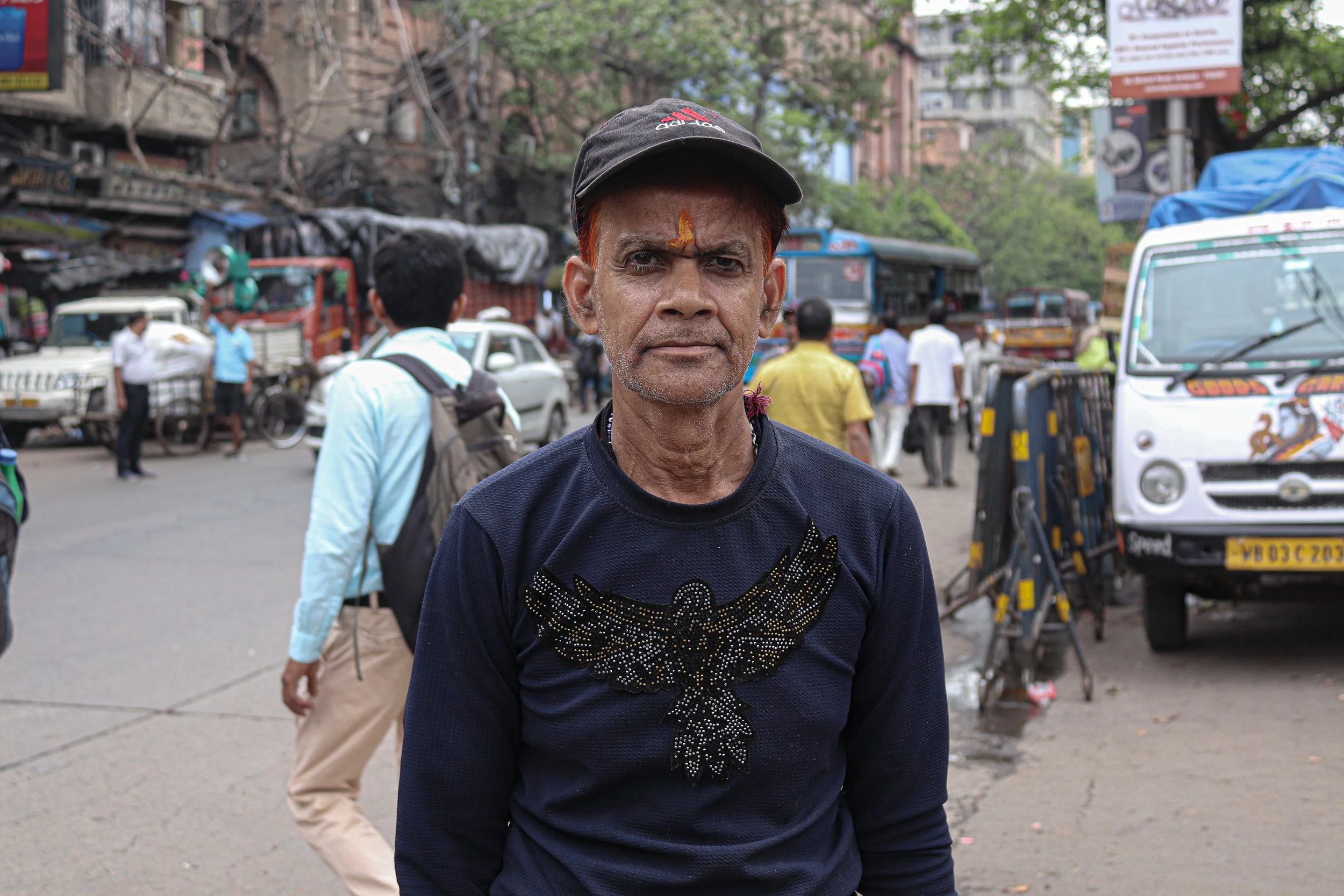 Kolkata, 2023 - I was walking across the road trying to weave through traffic when this man approached me telling me to take a photo of him. I said of course, when I showed him the photo he smiled and nodded at me before disappearing back into the bu