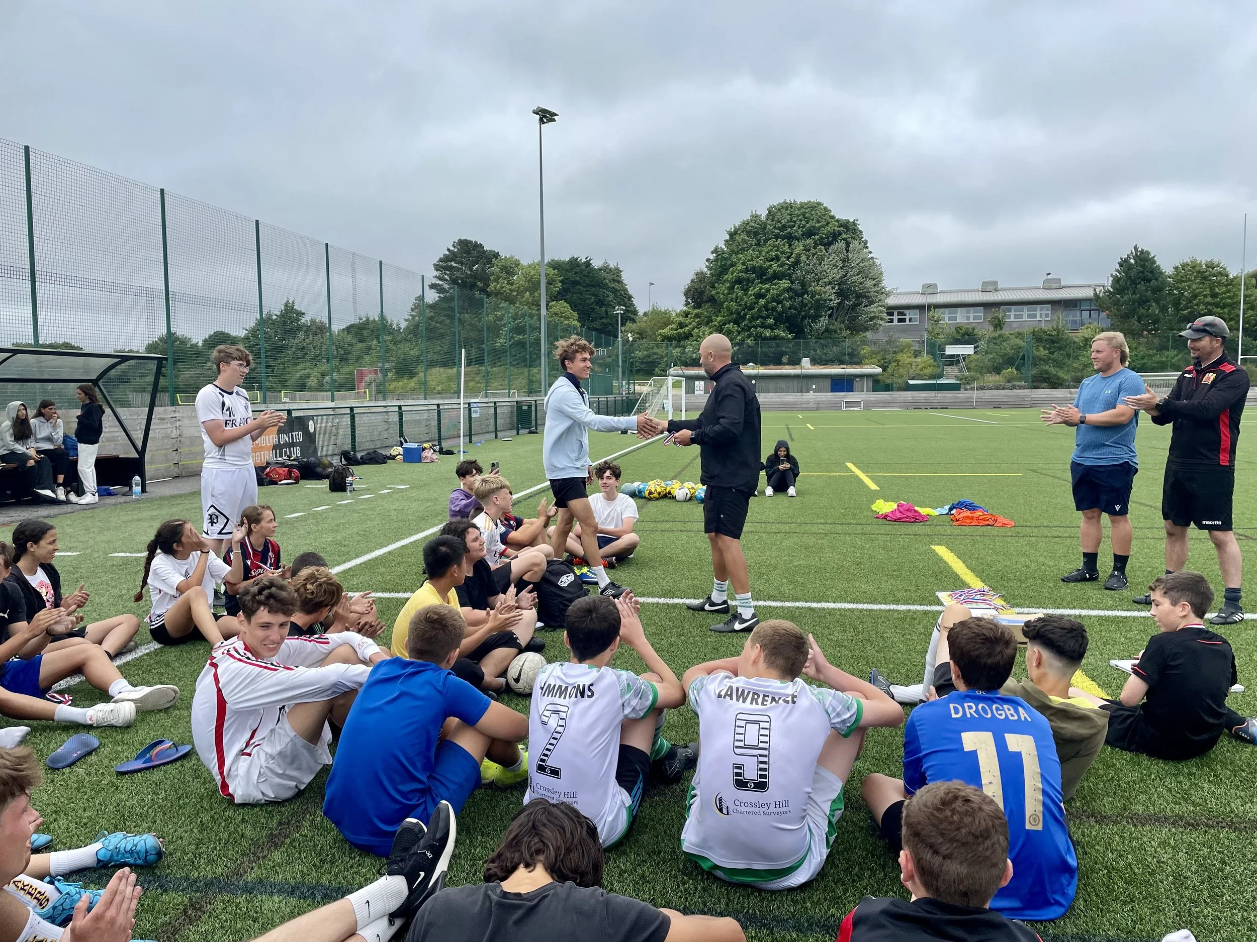 Congratulating students at the end of a football camp