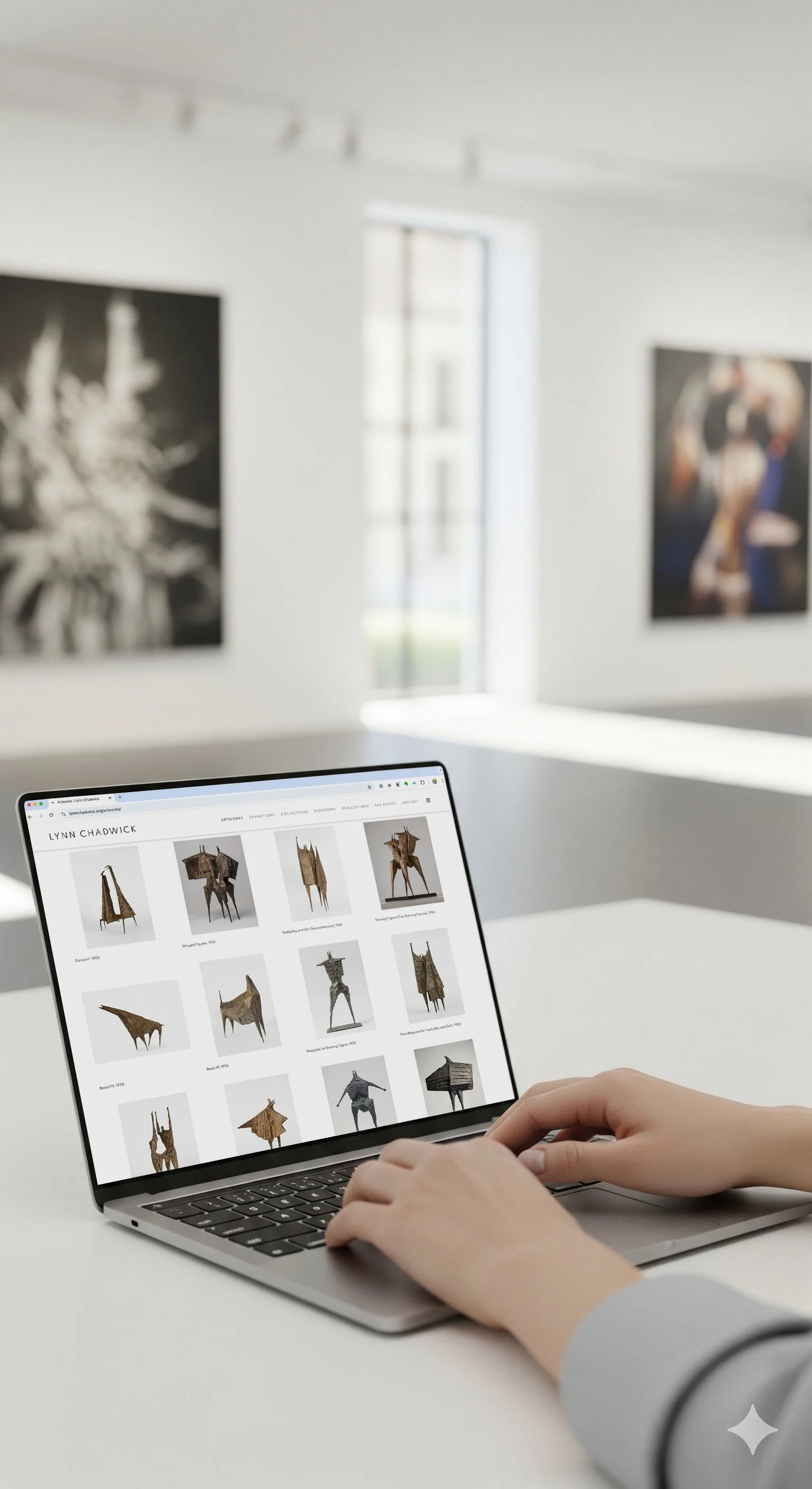Person browsing art sculptures on a laptop in an art gallery.