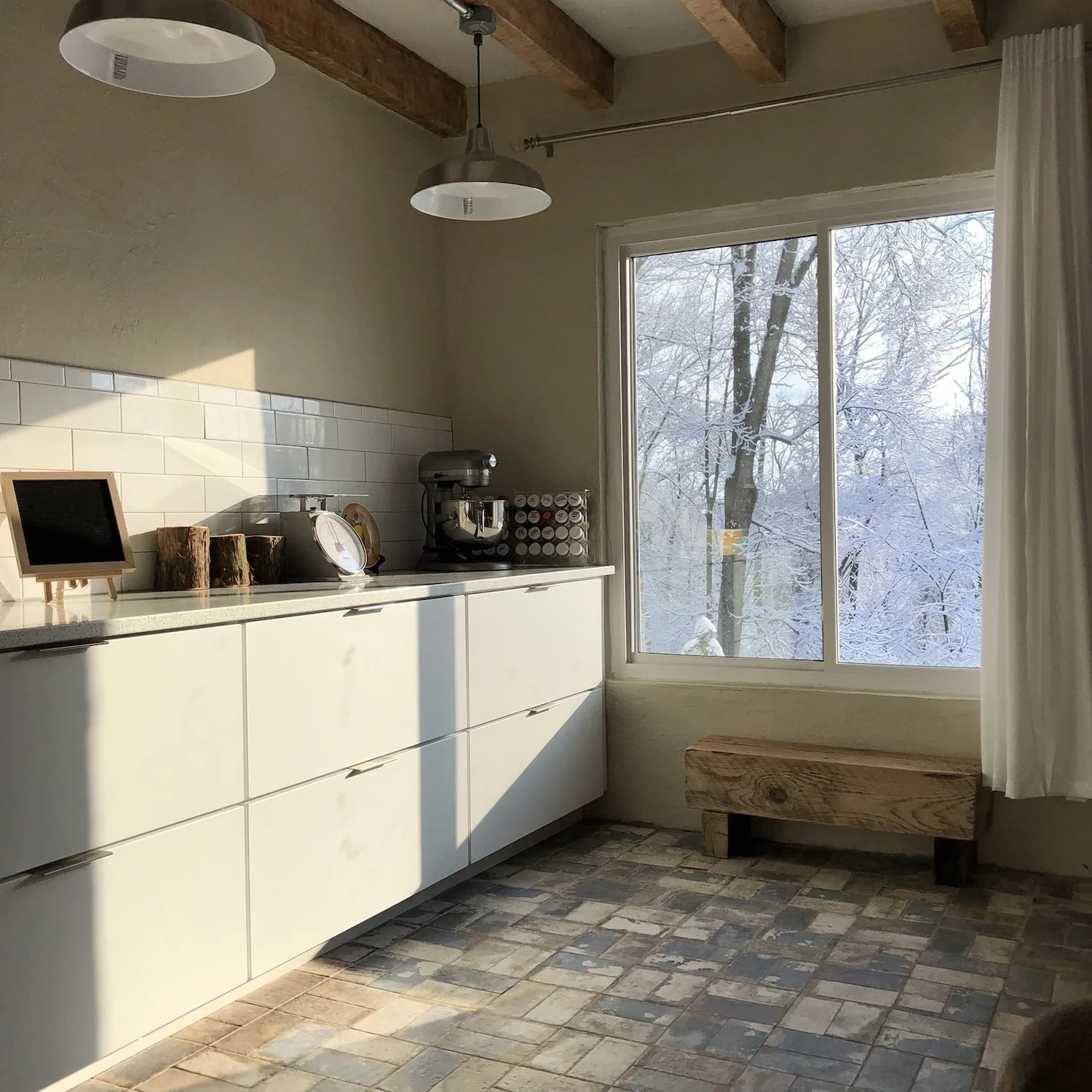 The sunlit East end window in the Winter after snowfall in the morning