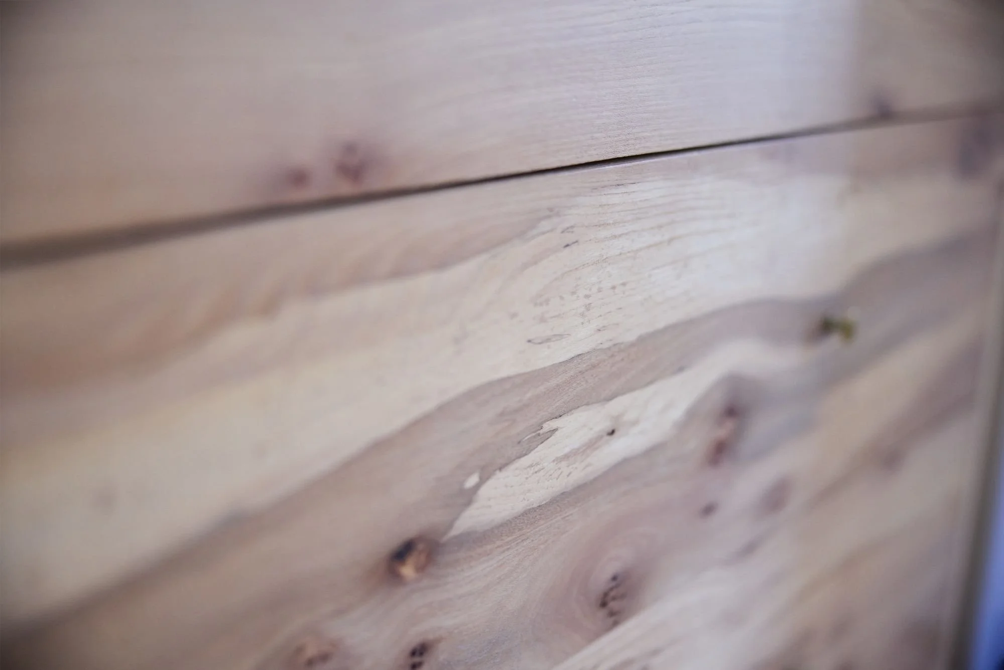 Detail of sustainably sourced British elm drawer fronts on a bespoke alcove cabinet