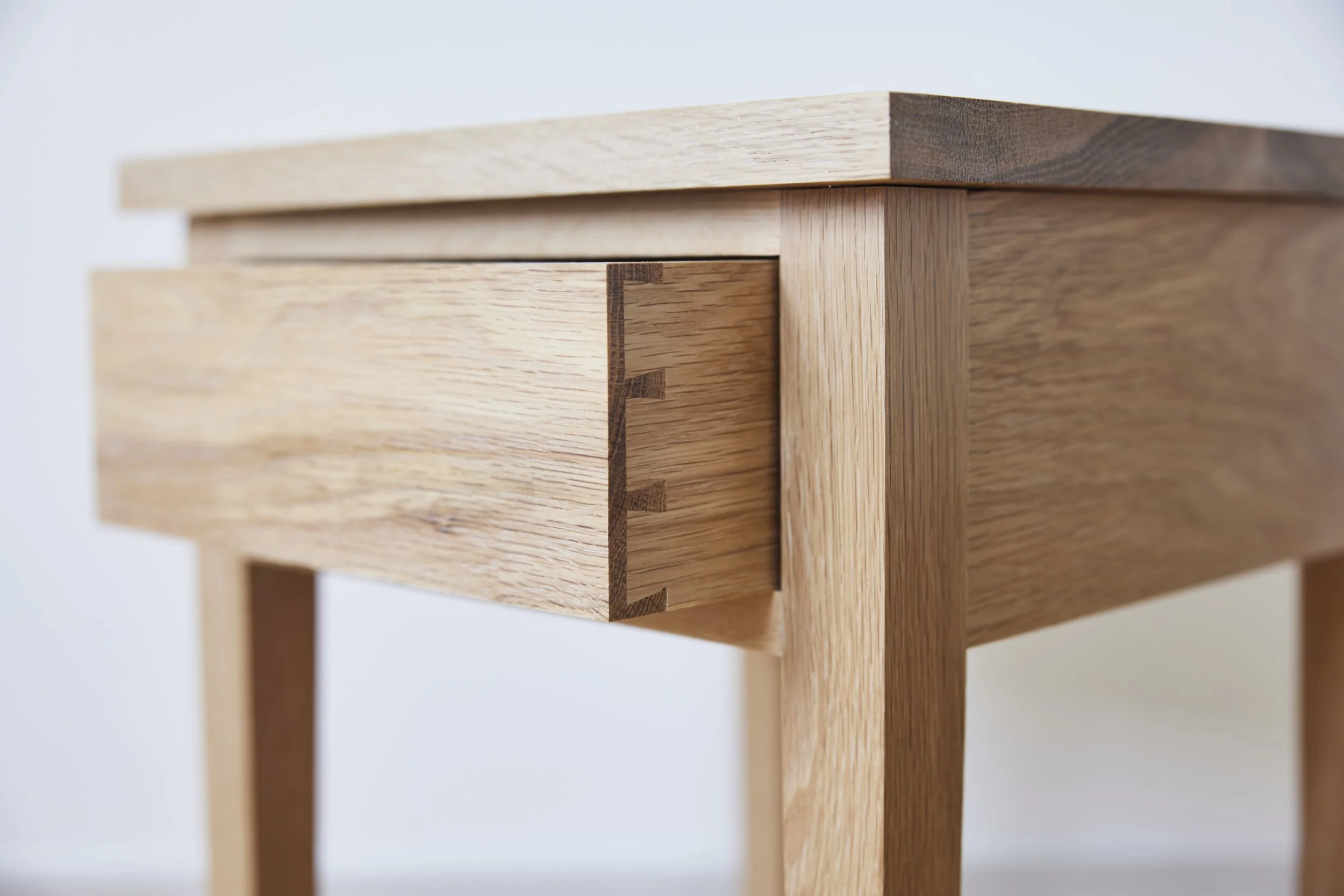 close up of handcut dovetails in solid british oak handcut in our countryside workshop near the cotswolds